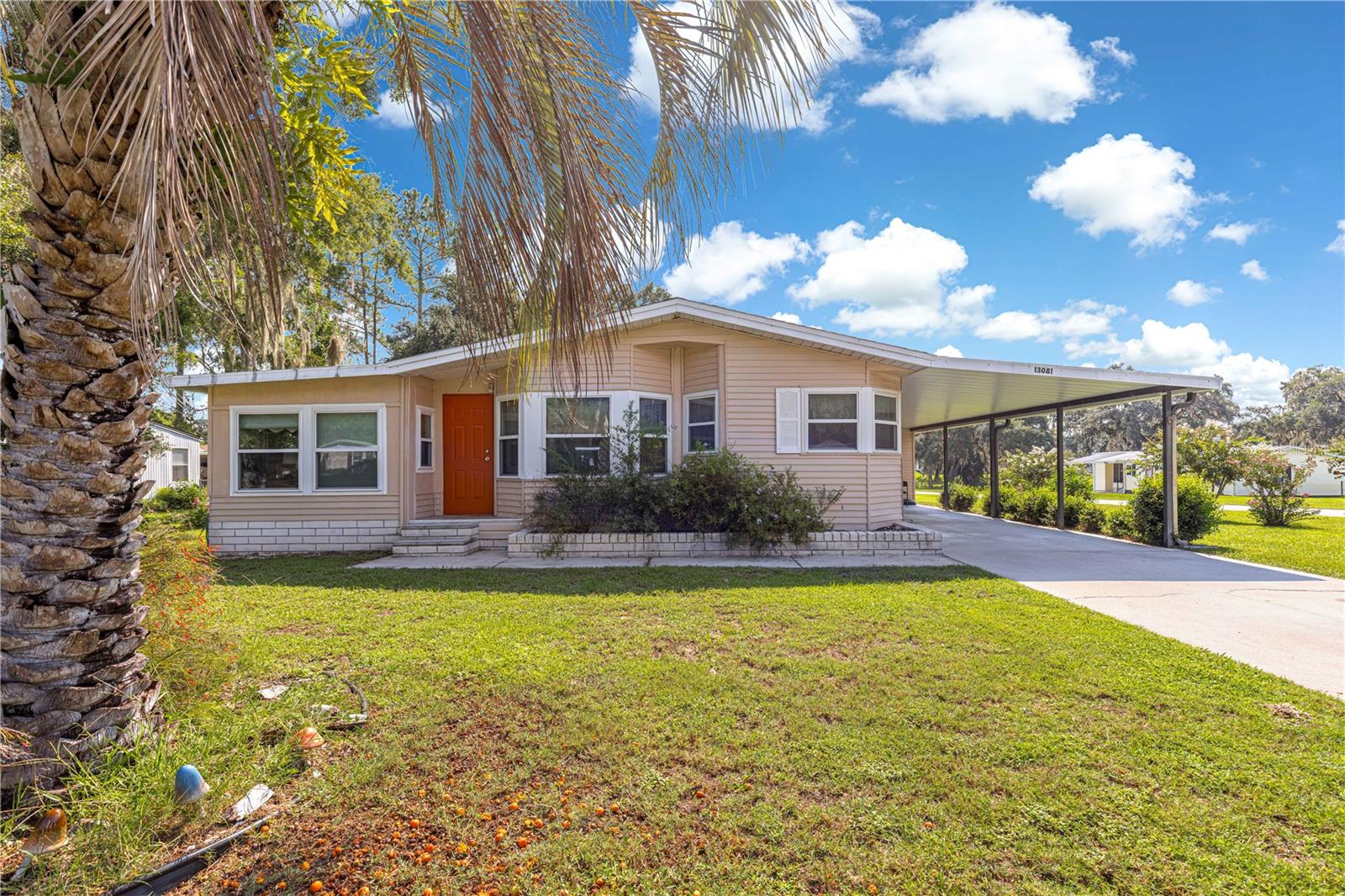 Welcome home, this manufacture home has been well taken care of, and it shows, this house has also been recently painted on the outside. This is where value and quality meet in this carefully maintained 2-bedroom, 2-bathroom retreat, complete with land ownership you own .28 of an acres! There are also two separate sheds behind the property for extra storage space. Perfect for year-round living or a winter getaway, this property has it all. This home has been well-maintained—The roof is 2022, The HVAC is 2019, The water heater is a 2024, The Septic tank was cleaned/ pumped out in 2022. 13 Windows were replaced/ upgraded with new ones in 2013. A generator with a propane tank also added in 2019 in case backup power is needed. As you drive up, you'll be greeted by an oversized carport, in this lovely corner lot leading you to a spacious shed and you can enter home through here or the front door. This home is being offered turn-key meaning furniture and dishes, utensils, appliances, bed dressings, window treatments and more will be staying with the home... The Collectible tractors and toys you see in pictures do not convey, and personal items do not convey. The Ac Wall units you see are not guaranteed to work the owner does not use them. The HVAC works great! You have two cozy FL rooms, one is being used as a den, and the other is being used as a third little bedroom for guest. These additional spaces are ideal for curling up with a book, setting up an office or savoring a refreshing iced tea while enjoying the window view! The primary suite boasts an ensuite bath with a walk-in shower. The guest bedroom has a guest bathroom right across from it. This home sits on a little over 1/4 acre, and being a corner lot, it enhances your ample space, along with the extra storage offered by the shed. With a low monthly HOA that covers trash and water services, and all the amenities including a community pool this home sits on a prime location providing easy access to travel to The Villages, Ocala, major highways, and I-75. You are just minutes away from the Marion County Flea Market and you have a Dollar General just around the corner, less than 2 miles. Don’t let this opportunity slip away! Schedule a showing today in person or virtually and discover all that this lovely home has to offer!