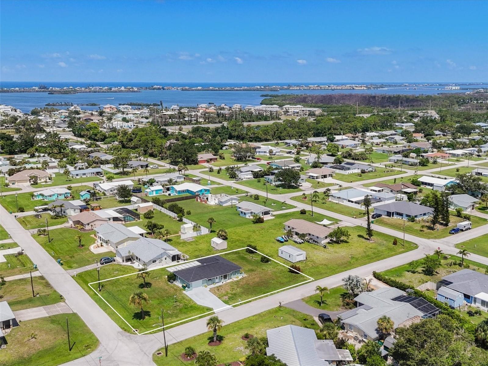 5 Minutes to the Boat Ramp, 5 Miles to the Beach & X Flood Zone…What More Could You Ask For! This charming 2-bedroom, 2-bath home is located in the heart of Grove City, just minutes from local restaurants, tiki bars, and the shops and beaches of Boca Grande. Situated on a spacious, oversized corner lot, there's ample room to add a pool, design your own tropical backyard retreat, or build a detached garage for storage or hobbies. Major updates include a new roof in 2023 and a new A/C system in 2024, giving you a head start on major expenses. Inside, you'll find a bright and airy open living area with a bay window and vaulted ceilings in the great room, along with a desirable split-bedroom floor plan. The kitchen has been thoughtfully updated with white shaker-style cabinets, quartz countertops, stainless steel appliances, and a stylish modern backsplash. Just off the kitchen, a cozy breakfast nook overlooks the lanai, an ideal spot for morning coffee. The spacious Florida room features a designer chandelier and could easily be converted to a second living space or family room. The primary suite includes a beautifully renovated ensuite bathroom with an oversized dual-sink vanity and a large, fully tiled walk-in shower with multiple shower heads. Guests will enjoy their own comfortable bedroom and a full bath with a tub/shower combo. Step outside to the large screened lanai with tile flooring and plenty of space for outdoor furniture, perfect for enjoying sunny days and peaceful evenings. With no HOA and room to park your boat or trailer, plus easy access to shopping, dining, schools, medical facilities, and top-tier boating and fishing, this home is ideal for full-time living, investment, or as a warm-weather escape from northern winters. Don’t miss your chance, contact us to schedule your private showing at 2620 12th Street today!