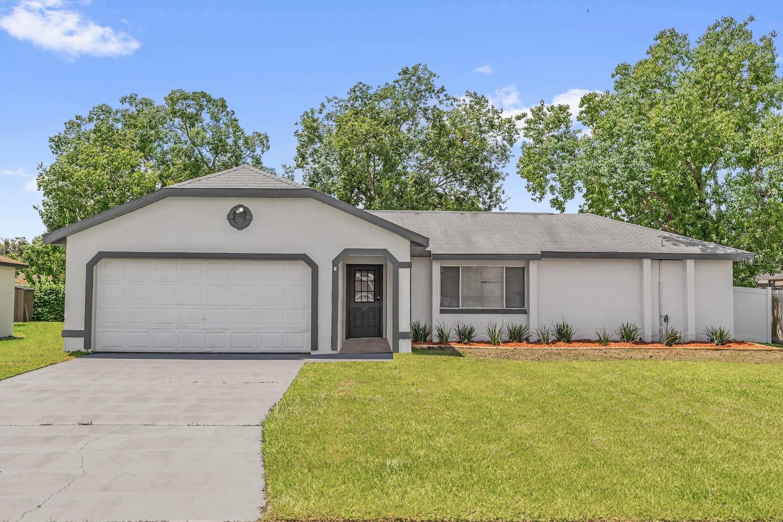 One or more photo(s) has been virtually staged. Recently updated 3-bedroom, 2-bathroom home in Kissimmee! Freshly painted inside and out, this home features waterproof luxury vinyl plank flooring in the living areas and bedrooms, accented by 5” baseboards and updated fixtures. The brand-new kitchen includes stainless steel appliances, quartz countertops, and a stylish backsplash. Both bathrooms have new toilets, vanities, fixtures, and beautiful porcelain tile flooring. The thoughtful layout offers multiple living and dining spaces, a screened patio, and a spacious 2-car garage.