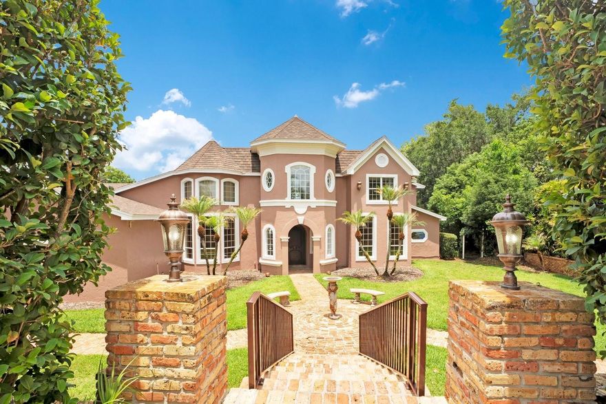 Nestled within a private gated community on 1.6 sprawling acres along the shores of Lake Arietta (a pristine 739-acre private lake), this south-facing Mediterranean Revival estate offers an unparalleled sanctuary of luxury. A grand circular drive leads to a dramatic entryway featuring a hand handcrafted front door by Gregor(previously featured in Architectural Digest). The interior boasts soaring ceilings, opulent travertine and rich wood flooring, crystal chandeliers, wrought iron balustrades, and a Chicago brick fireplace with an imported Trumeau mantel.

Designed for the epicurean, the main kitchen features premium cabinetry, granite countertops, a Sub-Zero refrigerator/freezer, and a professional-style dual-fuel gas range, plus a morning kitchen with dual wine cabinets. The expansive family room features slate floors and corner stacking sliders framing panoramic pool and lake views. Perfect for entertaining, the indoor climate-controlled second kitchen boasts a commercial Captiveaire hood with industrial ventilation/fire suppression, specialized Fire Magic professional-grade grills, a 1200-degree searing station, Recteq wood pellet grill, Aurora gas grill, keg cooler, and ice maker.

Luxury amenities abound: a custom 300-bottle wine cellar, a state-of-the-art movie room wired for whole-home audio (equipment conveys), and a Florida room under a vaulted tongue-and-groove wood ceiling with a wet bar and bay windows. The palatial downstairs primary suite serves as a private oasis with a sitting area, private lanai, lake views, custom walk-in closet with an independent washer/dryer, and a lavish bath with a copper sink and Brizo rain-head shower system. Upstairs features a split plan with 4 bedrooms and 2 baths (one ensuite; three sharing a Jack-and-Jill bath).

The outdoor oasis features a saltwater pool with Pentair controls, a vanishing-edge waterfall, a hot tub, and a sunset grotto with waterfall. A pristine boat dock (built 2025) features a 2-craft capacity, fully equipped with an electric boat lift and a dedicated personal watercraft (PWC) lift. The entire estate is backed by a full-home Generac generator. Parking includes an oversized attached 3-car garage plus an immense, detached 2,500+ sq ft RV garage. The RV space is fully air-conditioned (5-ton system) with two 18x16 doors, doubling as a luxury pool house with a full bath. An adjacent oversized parking area includes two additional RV hookups and flush-outs. A masterful convergence of architectural elegance and recreational indulgence on a premier private lake!