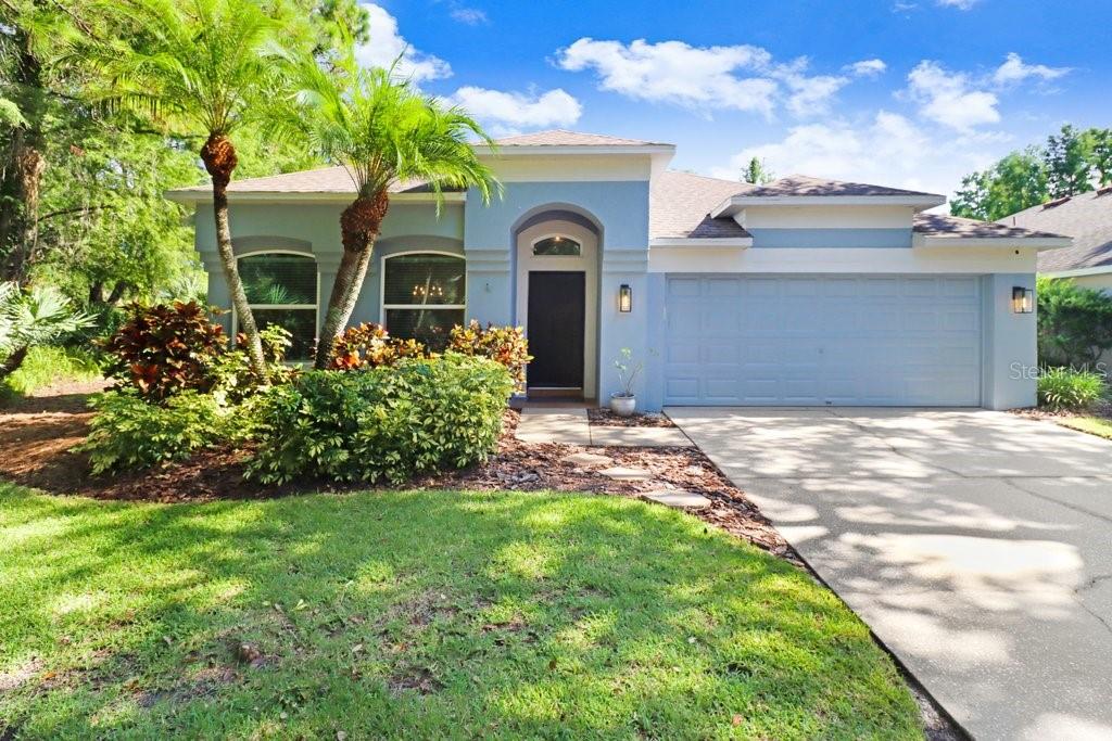 This move-in ready pool home sits on a corner lot with peaceful pond views and is zoned for top-rated Westchase Elementary. The spacious kitchen features granite countertops, white shaker cabinetry, a center island, tile backsplash, stainless steel appliances, and an open layout that connects to the living area making it perfect for both daily living and entertaining. The home includes crown molding, rounded corners, neutral finishes, and an inside laundry room. Bathrooms have been updated with a guest bath renovation in 2022 and a remodeled primary bath in 2019. Primary bathroom includes a walk in closet with custom built-ins, soaking tub, dual vanities, and a frameless glass shower. In 2021, PGT hurricane-impact windows were installed along with a hurricane-rated slider and front door, providing energy efficiency, noise reduction, and storm protection. Additional upgrades include a new AC in 2025, exterior paint in 2021, new pool pavers in 2022, full home re-pipe in 2016, resurfaced pool in 2013, and updated pool equipment. The screened lanai features a salt water chlorinated pool and spa with upgraded pavers and is surrounded by lush trees offering a private outdoor oasis for relaxing, grilling, or entertaining. Located in Westchase, a master-planned community with two swim and tennis centers, six tennis courts, six pickleball courts, lap lanes, playgrounds, parks, nature trails, a public golf course, and the vibrant West Park Village with shops, restaurants, and regular community events. Just 0.5 miles to Publix and minutes to the Veterans Expressway and Tampa International Airport.