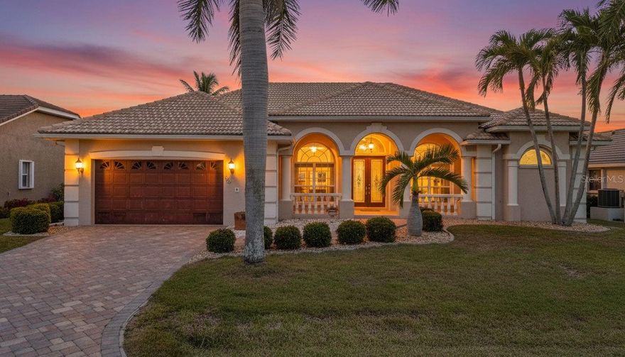 One or more photo(s) has been virtually staged. Welcome to a truly exceptional waterfront residence in Burnt Store Isles, where space, comfort, and coastal elegance come together in one of the area’s most desirable boating and golf communities. Lovingly maintained by its original owner, this thoughtfully designed home reflects pride of ownership throughout, including a new AC system installed in 2023. From the moment you step inside, you’re greeted by a bright layout designed for both everyday living and effortless entertaining. A stunning formal dining room, framed by graceful arched front windows, is bathed in natural light and creates an elegant first impression. Just beyond, a dedicated home office sits behind beautiful French-Style Glass sliding office doors featuring full-height glass panels with classic divided-light grids,  allowing you to close off the space for privacy and quiet, perfect for working remotely without interruption. The home flows into spacious living room, where triple sliding glass doors open wide to the screened lanai, creating a true indoor outdoor Florida living experience. The kitchen is both functional and inviting, featuring abundant cabinetry, expansive counter space, a cozy breakfast nook, and not one but two pantry spaces for additional storage. The first floor offers three generously sized bedrooms, two full bathrooms, and exceptional storage throughout, including numerous closets and a substantial under-stair storage area. The large laundry room is complete with extensive cabinetry above the washer and dryer, and even a second refrigerator with an ice maker! The primary suite serves as a private retreat with dual vanities, a soaking tub, and a separate shower designed for relaxation. Upstairs, a private fourth bedroom can serve as a secondary primary suite, accessed by its own staircase and featuring an en-suite bath with linen closet and a beautiful balcony, providing ideal privacy for guests. Step outside and experience where this property truly shines. Your private backyard retreat features a heated in ground pool, an outdoor shower, and a paved outdoor sitting area with a built-in fire pit, perfect for entertaining. The lush tropical landscaping includes coconut and banana trees, all supported by a sprinkler system to keep the grounds looking their best year round. Boaters will appreciate the concrete dock with a boatlift already in place, allowing you to head straight out to the Gulf with ease! With a southwest exposure, this home is placed perfectly for amazing sunsets. This is true Southwest Florida waterfront living! This home also features an extra large garage, with a dedicated workbench area, that comfortably accommodates large SUVs. Enjoy access to the nearby golf course and amenities while being just minutes from shopping, dining, boat launches, schools, and local attractions. This home offers the rare combination of peaceful canal front living, recreational convenience, and refined coastal comfort.