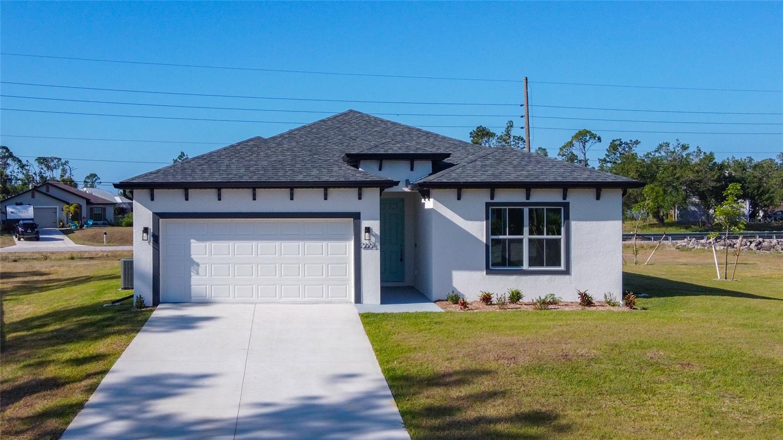 MUST SEE - NEW CONSTRUCTION - Completed, move-in ready, cul-de-sac larger lot that backs up to a canal. This concrete block 4-bedroom 3-bathroom 2 car garage home boast a modern design with high ceilings and features an open spacious floorplan design. With an awesome gourmet-inspired kitchen that features white cabinets with a large center island and subway backsplash and upgrades that include Stainless-steel Samsung appliance package with washer and dryer. Luxury wood-vinyl flooring throughout the common areas. A spacious master bedroom with tray ceilings, two walk-in closets, a private bathroom with dual vanity area, and large open walk-in shower. Front bedroom with bathroom is perfect for a guest room, mother in-law suite, or office. Home also features indoor laundry room connecting the attached garage, double pane windows, and sliding glass door that lead out to the open lanai. This brand new home is a must see!