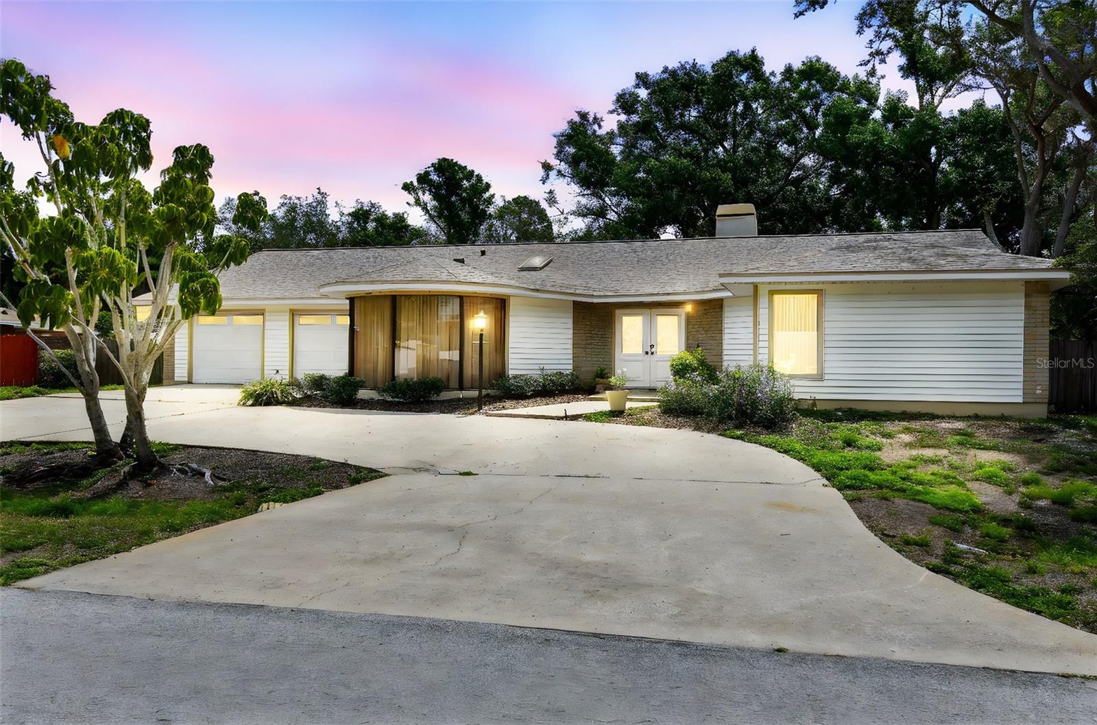 Spacious Pool Home with Endless Potential in a Prime Location Near Walsingham Park Discover a rare opportunity to own a generously sized pool home in a highly desirable area—just steps from the scenic 354-acre Walsingham Park. Located on a quiet, well-kept street where neighbors take pride in their homes, this property offers incredible space, a flexible layout, and solid construction—ready for your updates and personal touch. Set on a large homesite with a beautiful front yard, circular driveway, and a 2-car garage with separate doors, this home offers great curb appeal. Step through double half-glass front doors into a wide, welcoming foyer with ceramic tile floors and plenty of natural light. To the right of the foyer, a private guest wing features two oversized bedrooms with new luxury vinyl plank flooring and full-wall closets. A spacious vestibule offers additional privacy and includes a massive linen closet, while the large guest bathroom features ceramic tile flooring, generous counter space, and a dedicated storage cabinet. To the left of the foyer sits a sprawling kitchen that holds vintage charm and serious potential. Highlights include solid wood cabinetry, ceramic tile countertops, a vaulted ceiling with skylight, ceramic tile flooring, a large pantry, laundry closet, and a bright breakfast nook with sliding glass doors that lead to the screened lanai. Adjacent to the kitchen is a formal dining room with laminate vinyl plank flooring and mitered glass windows overlooking the front yard—ideal for future entertaining or renovation. The living space continues with an oversized, sunken family room featuring a vaulted ceiling, ceramic tile floors, plenty of recessed lighting, and a cozy gas brick fireplace with a full hearth and mantle. Beyond the family room, a bonus room with wet bar and luxury vinyl plank flooring offers endless flexibility—use it for games, hobbies, a home gym, or a future media room. The expansive primary suite is tucked away at the back of the home for added privacy. This room features vaulted ceilings, a skylight, carpeted flooring, and large windows that overlook the pool area. A bonus alcove within the room is perfe