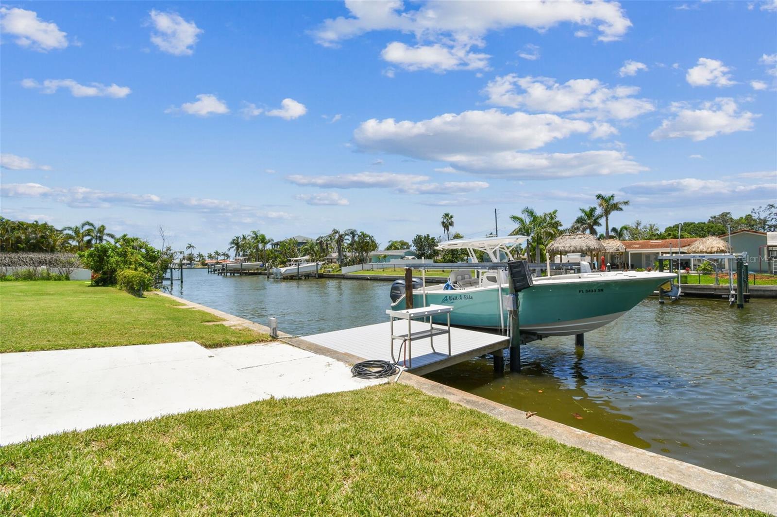 Welcome to this beautifully updated 2236 sq ft, 3 bedroom, 2 bath, 2 car garage, pool and waterfront home set in the coveted Oakhurst Shores neighborhood. This residence truly embodies the essence of Florida waterfront living. With its combination of spacious indoor-outdoor living, proximity to some of the area’s best waterfront destinations, and a welcoming community atmosphere, this gem invites you to create a lifestyle as relaxed or as lively as you desire. Brand new updates include floors, woodwork, interior doors, kitchen and bath cabinets. There are hurricane rated front and garage doors as well as 4 newer hurricane rated sliding glass doors providing views and access to the pool and waterfront. Once outside you can enjoy the freshly resurfaced pool or head to your boat dock with its 9000 pound lift and head out for a day on the water. Located on a deep-water canal you are just minutes away from Boca Ciega Bay and a short boat ride to Johns Pass and the open waters of the Gulf. This concrete block home sits on an oversized corner lot and provides amazing space for entertaining outdoors. Inside you will find an open living space featuring the kitchen, dining room and family room all with pool and water views. The flex space next to the family room is currently being used as an office, exercise and laundry room. No doing laundry in the garage here. Additionally, there is a large formal living room separated from the great room at the front of the house. The primary suite has 2 built-in closets and is ensuite with a large walk-in shower. The 2 additional bedrooms provide space for family or guests. This residence is more than just a house—it’s a gateway to a vibrant lifestyle promising comfort, beauty, and endless possibilities by the bay. Schedule your private tour today and discover all the possibilities that await in your new coastal sanctuary.