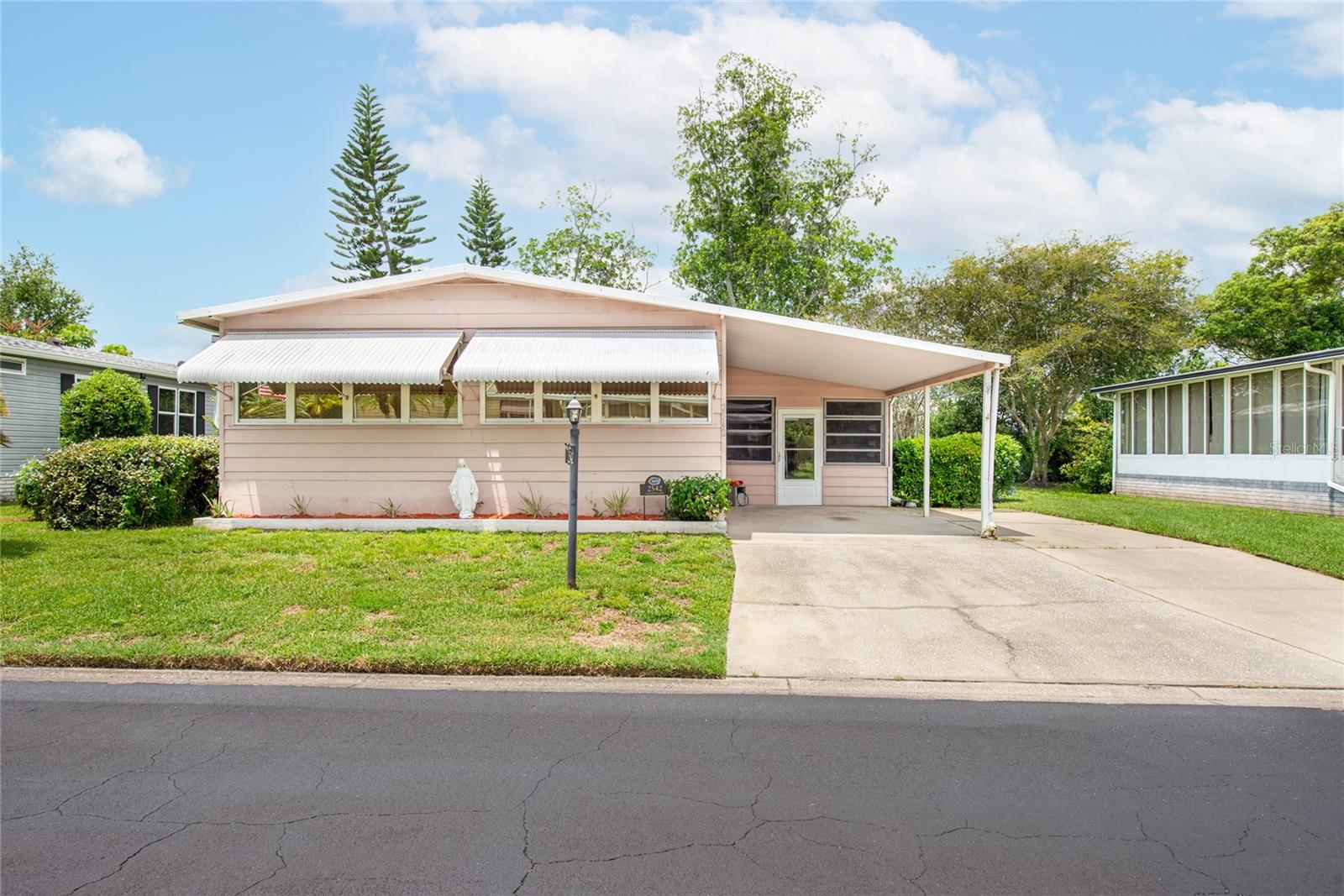 Spacious 2BR/2BA manufactured home in the desired community of Teka Village, 55+ community. This AS-IS property features a large Florida room with windows, large living room, separate dining room area with attached hutch, kitchen features range, refrigerator, dishwasher. Family room with lots of natural light and windows. Master bedroom with plenty of closet space, master bathroom shower and 2nd bedroom with multiple closet space. Outside in the Florida room area is space for the laundry room and also a work/storage area. 13 month HWA Home warranty provided for buyer by seller. This 55+ gated community features a club house that offers many events and celebrations, large lap room, area for bbq, kitchen and sit in area. A great feature is the location of this community is within minutes to the turnpike, shoppings, restaurants, hospitals, 40 min drive to the beach, 30 min drive to Lake Nona and 30 min to Orlando International Airport. This property can be a perfect primary home or for snowbirds as a secondary home to enjoy during those winter months.