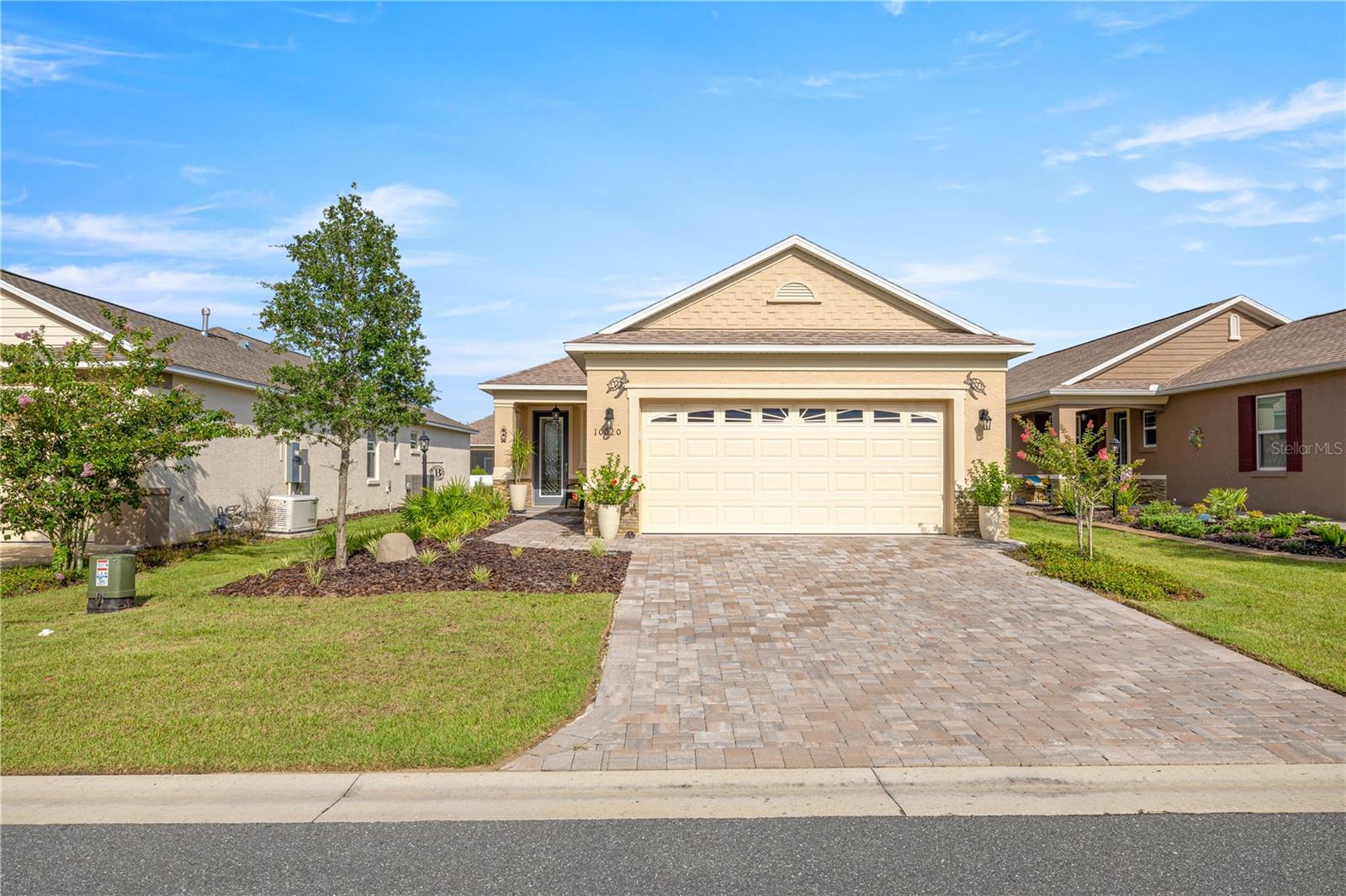 Welcome to this bright, open, and impeccably upgraded 2-bedroom, 2-bathroom home, located in the highly desirable 55+ community of On Top of the World. From the moment you arrive, you’ll be impressed by the stone-accented exterior, stone driveway, and upgraded front entry door that set the tone for the quality found throughout this home. Inside, enjoy a spacious open floor plan with luxury vinyl plank flooring throughout, custom crown molding, tray ceilings, and ceiling fans in every room. The kitchen is a chefs dream with soft-close cabinets and drawers, granite countertops, tile backsplash, under-cabinet lighting, upgraded stainless sink and dishwasher, and detailed crown molding for a finished look. The inviting living and dining areas feature a custom mirrored accent wall, and the flow continues seamlessly to the screened-in lanai—complete with insulated ceiling, TV outlet, custom blind, upgraded CMU wall, and stone extension, making it the perfect place to relax or entertain. Retreat to the master suite featuring custom-built closet organizer, granite bathroom countertops, a walk-in tiled shower with stone flooring, and soft-close cabinetry. The guest bathroom has also been upgraded with granite countertops, modern fixtures, and matching cabinetry. The garage is fully finished with an insulated door, epoxy-coated floor, extra electrical outlets, pull-down attic ladder with storage and lighting, bike pulleys, and an Aquasure water softener. Located in a community that offers resort-style amenities, including pools, golf, fitness centers, clubs, and countless social activities, you’ll have everything you need to live an active and fulfilling lifestyle.