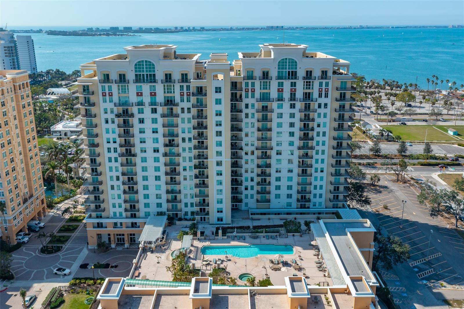 This extraordinary 12th-floor corner unit in the South Tower at Alinari offers panoramic bay and city views from every angle, making it an unrivaled gem in Sarasota's downtown bayfront. With a spacious layout featuring wrap-around balconies accessible from the main bedroom and living room, plus a third balcony off the guest bedroom, this condominium home feels like an extension of the beautiful outdoors. Upon entering, you’re greeted by high ceilings and luxurious wood flooring in the foyer, dining room, kitchen and living areas, exuding elegance and sophistication. The kitchen boasts quartz countertops and other thoughtful upgrades, enhancing functionality and beauty. The open-concept living spaces flow seamlessly, maximizing natural light and creating an inviting environment for entertaining or simply relaxing while enjoying the stunning vistas. The generously sized owner’s suite offers a private retreat, providing ample space to unwind in comfort. This home is in the heart of Sarasota’s vibrant downtown, where culture, art and entertainment come together with luxury living. You’re just steps from iconic landmarks such as the Van Wezel Performing Arts Hall and Sarasota’s cultural heart. Whether you enjoy world-class performances one night or a serene visit along the bay the next, all of this is within reach from your front door. For those seeking convenience, a second parking space conveys, and top-of-the-line amenities are right at your doorstep. The building offers 24-hour security, a heated lap pool and spa, a state-of-the-art fitness center, media room, business center, library, wine cellar and more. Whether you’re hosting friends in the large club room, relaxing in the sauna or enjoying the outdoor grilling area, this residence is designed to offer you an elevated lifestyle. Step outside and witness the exciting future of Sarasota Bay with the transformation of The Bay Sarasota, an ambitious development that’s creating a cultural and economic legacy for the region. In this prime location, you’ll have unparalleled access to fine dining, shopping and the burgeoning Rosemary District. Plus, Lido Beach is just a short drive for the ultimate escape. This is your chance to own a piece of Sarasota’s future, where the city meets the sea, and every aspect of your lifestyle is catered to. Don’t miss the opportunity to make this extraordinary home yours.