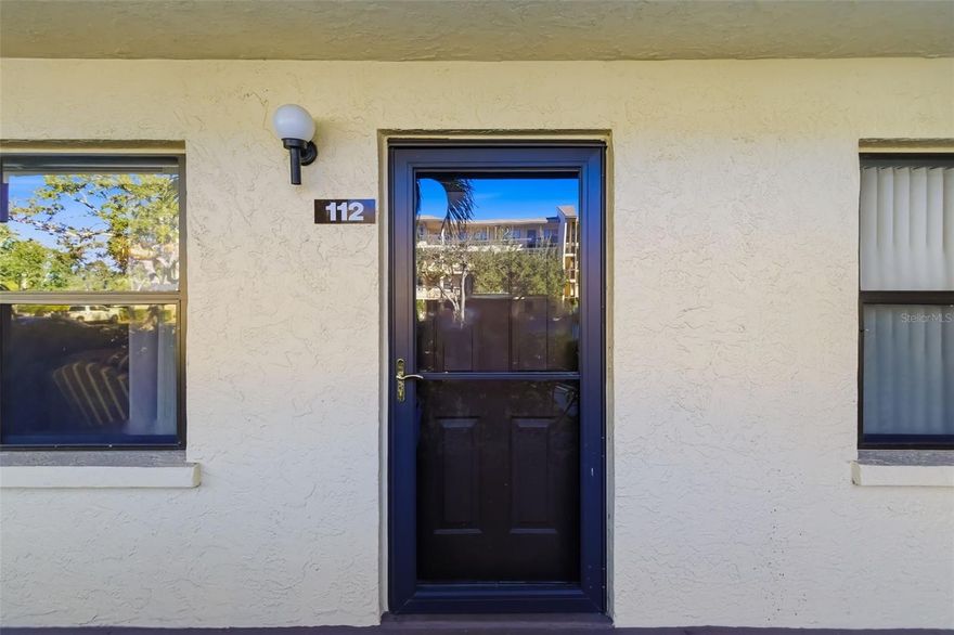 Welcome to DeSoto Square Villas, a highly desirable 55+ gated community offering comfort, security, and an active Florida lifestyle. Tucked away from the hustle and bustle—yet conveniently located next to the Sheriff’s Office—this community is known for peace of mind and reliability, even during power outages (it is on same circuit as Sheriff - a bonus). Desoto Square Villas is close to medical care.

Once inside the gates, you’ll feel as though you’ve entered a private garden retreat, with beautifully manicured grounds, a charming fountain, and walking paths ideal for morning or evening strolls. Residents enjoy a vibrant 55+ lifestyle with a community pool, pickleball and tennis courts, and an activity center offering a full schedule of social events, clubs, and gatherings.

Step inside the villa and be impressed by the spacious open living and dining area, perfect for entertaining or relaxing in comfort. All furnishings convey, including a versatile sofa that converts to a daybed—making this a truly move-in-ready home.

The second bedroom is thoughtfully designed with its own bathroom and can be closed off to create a private guest suite, ideal for visiting family or friends. A rare bonus: the washer and dryer are grandfathered in, eliminating the need to walk to a community laundry—especially convenient in the evenings.

Enjoy easy access to beaches, shopping, dining, medical facilities, and everyday conveniences without long drives. Whether you’re downsizing, retiring, or seeking a low-maintenance seasonal home, this DeSoto Square Villa offers the security, comfort, and lifestyle today’s 55+ buyers are looking for. Did I mention Pickleball?