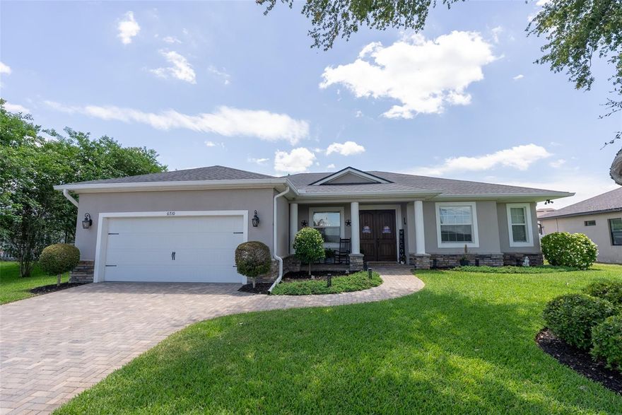 CUSTOM BUILT POOL HOME IN WINTERSET GARDENS WITH CHAIN OF LAKES ACCESS. Welcome to this beautifully maintained, one-owner custom home located in desirable, lake front Winterset Gardens. This spacious 4-bedroom, 3-bath residence is directly across the street from little Lake Winterset and features 10 foot ceilings, 8 foot custom doors and two true master suites (One with attached pool bathroom), each with walk-in closets, offering flexible living for multi-generational families or guests. Built with quality and efficiency in mind, the home includes a 45-year architectural shingle roof, foam-filled concrete exterior walls, and extra attic insulation. Inside, you’ll find wood plank tile flooring throughout, Level 3 granite surfaces, and semi-custom solid wood cabinetry with dovetail soft-close drawers in the kitchen, bathrooms, and spacious indoor laundry room. The kitchen is equipped with matching LG appliances, under-cabinet lighting, and a Delta touch faucet. Custom craftsmanship is showcased throughout with professionally trimmed  8ft. doors and windows, shiplap accent walls in the dining area, kitchen, and island, plus a stunning custom electric fireplace with mantel, hearth, and barn door cabinetry in the living room. The primary suite also features a matching custom shiplap electric fireplace for added comfort and style. Step outside to your fully fenced private backyard retreat featuring a saltwater pool with a variable speed pump, paver deck and pre-installed footers for a future pool enclosure. The covered lanai is designed for entertaining with an outdoor kitchen including grill, refrigerator, storage, and matching Level 3 granite. Enjoy the motorized screen, tongue and groove wood ceilings, and ambient lighting for the perfect indoor-outdoor experience. Additional highlights include Permanent app-controlled exterior lighting, Sprinkler system on well, leased water filtration and softener, Triple sliding glass doors that retract to fully open to the patio to the living area, Pre-wired surround sound system in living room, primary bedroom, and patio, Upgraded DC motor ceiling fans throughout, Tiled showers to the ceiling with rain shower in primary bath, Framed bathroom mirrors and comfort-height elongated toilets, Custom garage cabinetry, sealed floors, and hot/cold water hookup. Winterset Gardens is a highly respected, quaint neighborhood on the shore of Little lake Winterset and offers an optional $100 HOA with a community boat ramp and no deed restrictions allowing direct access to The world renowned Winter Haven Chain of Lakes. 24 canal connected lakes offering great fishing, skiing and leisure boating. Hop on your boat from your neighborhood and go get a bite to eat at several float up bars and restaurants. This home combines thoughtful and impressive upgrades, energy efficiency, and custom design in a highly sought-after location. Truly move-in ready and built to impress.