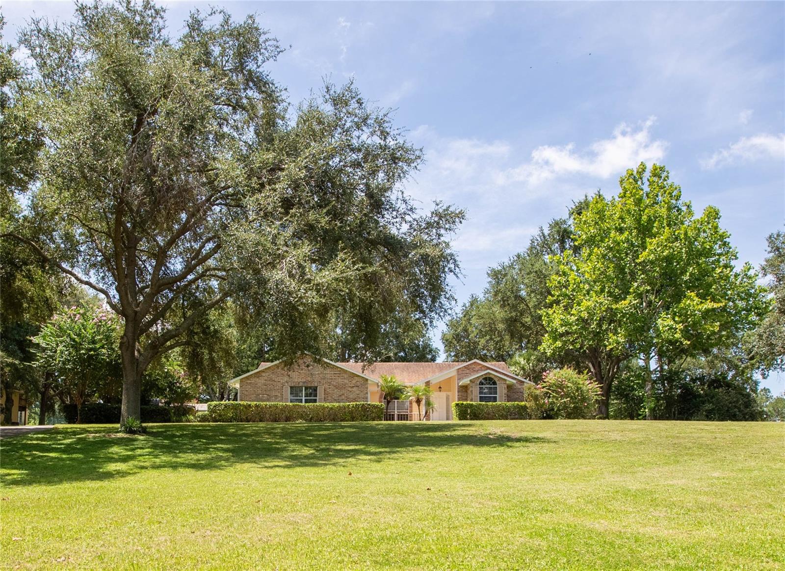 $50,000 PRICE ADJUSTMENT...Executive ranch / pool home in EXCLUSIVE EQUESTRIAN COMMUNITY bordering Bella Colina. This is a rare find sitting on 2.26 acres of land, fully landscaped with pristine oaks. Property has a three stall barn for horses and is on one of the many internal horse trails of the community. There are also community stables and arena riding areas within the community.
This well maintained home features oversized kitchen, with tall wooden cabinets, stainless steel appliances, breakfast nook and bar area connected to the family room with wood burning fireplace. From ever area of the home, you can see the large pool area, open lawn, horse stables and paddock. The Master Bedroom is separate from bedrooms 2, 3 and 4. Bathroom 3 is the pool bath with a standup shower and door opening directly to the pool. Montverde is one of the most sought after cities in Florida being located in Central Florida. It is close to shopping, dining, hospitals and amusement parks.