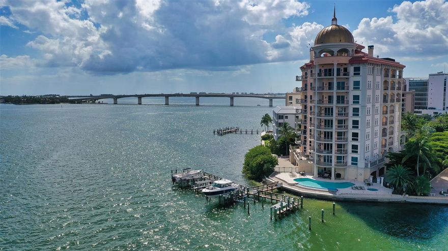 Experience the epitome of elegance and timeless sophistication in this exquisitely appointed three-bedroom residence. at the exclusive Grande Riviera, a breathtaking architectural gem nestled in the prestigious Golden Gate Point neighborhood. Meticulously maintained, this classic condominium offers panoramic views of Sarasota Bay and the sparkling downtown skyline, setting a new standard for luxury waterfront living. This residence boasts the largest terrace in Grande Riviera, approximately 2300 square feet,  providing the ultimate setting for sunsets and entertaining friends and family. One of only 13 exclusive residences, this home offers an intimate and private lifestyle, with a private elevator entrance leading directly to the elegant foyer. Designed for both comfort and grandeur, the residence features arched walkways, rich crown molding, and expansive living spaces ideal for entertaining or quiet reflection. The heart of the home is a remodeled chef’s kitchen, outfitted with a large center island, solid wood cabinetry adorned with sleek black hardware, a quartz backsplash, granite countertops, and a Sub-Zero refrigerator and freezer, as well as a Wolf gas range and double wall oven. Deluxe Laundry room with custom cabinetry and workspace conveniently located near the kitchen. A wet bar with a Sub-Zero wine fridge seamlessly connects the open living space to the elegant dining and living areas, creating a perfect flow for gatherings. Step outside onto the largest private wraparound terrace in the building, where you’ll enjoy breathtaking, unobstructed views of the bay. This is truly one of the most distinguished outdoor living spaces in the complex. The owners’ suite is a serene retreat, featuring dual walk-in closets with custom built-ins, and a spa-like bathroom with marble floors, a dual quartz vanity, walk-in shower with dual showerheads, and a private water closet. The suite also offers direct access to the terrace, allowing for peaceful mornings with stunning bay views. The guest suite boasts a private terrace entry, en suite bath, and walk-in closet, while a versatile third bedroom/ den with double glass doors can serve as an office, sitting room, or additional guest space. Additional features include a private, deeded two-car garage with storage, resort-style pool, rooftop terrace, boat docks, on-site management, and private secured access. This is a rare opportunity to own a distinguished waterfront home in one of Sarasota’s most coveted locations, a residence that masterfully blends classic design, modern comforts, and breathtaking surroundings.