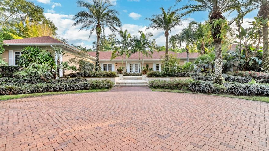 Leisure and luxury await you in this custom-designed home located in the picturesque and exclusive community of Mountain Lake. Tucked away down a private, tree-lined drive, this secluded retreat is the most private and serene property available in the community, offering unparalleled tranquility on just under two lush and meticulously maintained landscaped acres. Fully renovated in 2012, the bungalow features a stunning Tuscan-style kitchen with granite countertops, gas range and a spacious layout that’s perfect for cooking or entertaining enthusiasts. Filled with expansive windows allowing for generous natural sunlight, the thoughtfully designed three-bedroom, three-and-a-half-bath floor plan offers a warm, family-friendly atmosphere while providing fabulous spaces for hosting guests. The enormous master suite includes a spa-like bath, a morning coffee bar, double walk-in closets, and a private sitting terrace. Outdoor living is just as remarkable with a fabulous in-ground pool, a screened lanai, a pergola-covered terrace, and citrus grove steps away. With a new roof installed in 2023, this home is turn-key move in ready and offers the perfect blend of privacy, luxury, and convenience. Schedule your private showing today to experience everything this extraordinary property has to offer.