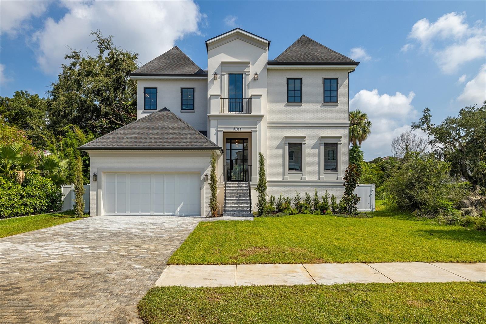 Welcome to your dream home in the heart of South Tampa! This stunning two-story new construction offers luxurious living with modern elegance and thoughtful design throughout. Boasting 5 spacious bedrooms, 5 full bathrooms, and 1 half baths, this home is perfect for families and entertaining.
Step inside through the grand foyer, where you'll be greeted by an open and airy floor plan. The first floor features a versatile guest suite, a convenient mudroom, and a tech room, perfect for working from home. The expansive great room seamlessly connects to the gourmet kitchen, which includes a large pantry, state-of-the-art appliances, and plenty of counter space for culinary adventures.
Step outside to your private oasis?an expansive covered lanai overlooks a sparkling pool and outdoor kitchen, ideal for year-round outdoor living and entertaining.
Upstairs, the master suite is a true retreat, featuring two generous walk-in closets and a luxurious ensuite bath with all the amenities you could desire. Three additional bedrooms, each with their own walk-in closets and ensuite baths, provide comfort and privacy for family and guests. A spacious loft and a convenient laundry room complete the second floor.
The home also includes a 2-car garage, providing ample storage and convenience. Located in the highly sought-after South Tampa area, this home offers proximity to top-rated schools, shopping, dining, and the beautiful Tampa Bay.