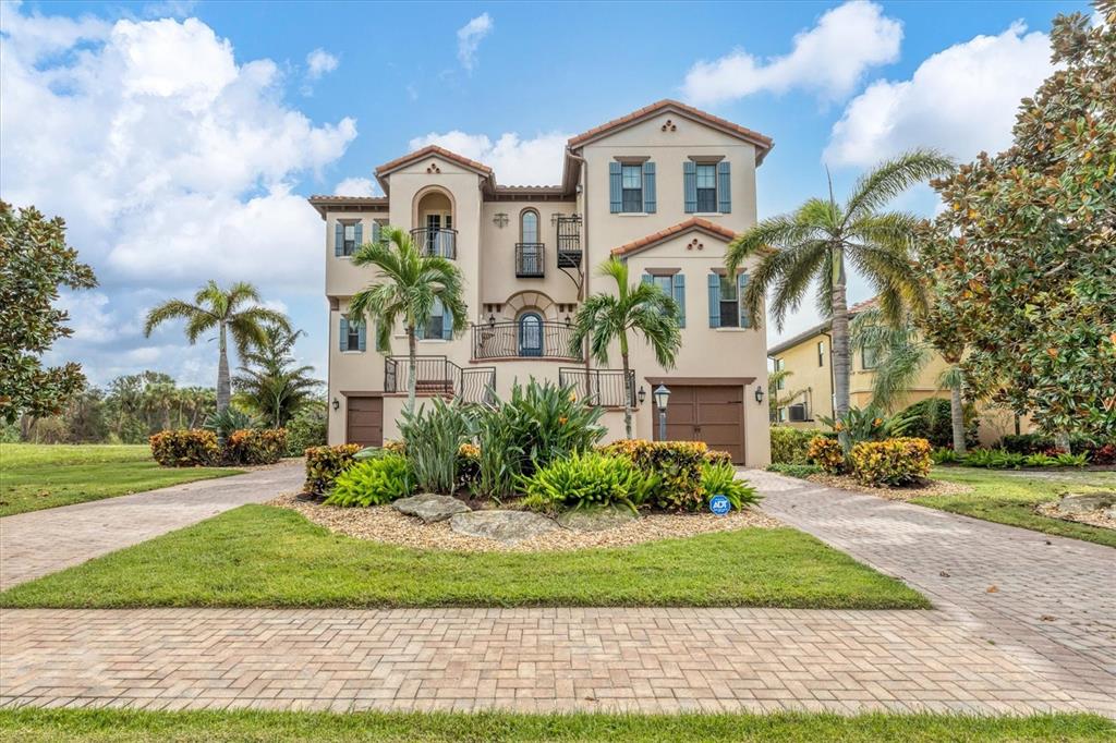 $400,000 PRICE REDUCTION! Nothing wrong with the house, but the Sellers motivation to sell is now your buyers benefit to buy. The ultimate in elevated and elegant charm runs through every room of this near 4,800-square-foot classy home sitting on panoramic views of Sarasota Bay. With lake views just off the back of the home, there are two stories of extensive terraces that give additional water views far beyond. The front of the residence offers a towering, elegant sight as the grand staircase leads you from the courtyard to the entrance of this custom Arthur Rutenberg design. The main floor features both casual and formal living spaces, with the formal living room boasting decorative plaster detail, two oversized windows, a double-sided fireplace and a wine storage room for more than 300 bottles. The home then leads you into the chef's kitchen, with an adjacent formal dining room, featuring solid wood cabinetry, stone counters and stainless steel appliances including a built-in microwave and oven. A center island can easily seat four for casual dining and a separate wet bar offers ease of entertaining as it faces the formal living room. From the family room, doors lead to the outdoor living space overlooking the community lake, mangroves and bay with the den through the parallel-facing set of doors. The primary bedroom suite completes this floor with dual walk-in closets, a spacious bathroom with a free-standing tub, separate vanities, a linen closet, a walk-in shower with dual showerheads and a toilet room with a bidet. Take the elevator or the magnificent wood stairway to the third floor featuring an additional bedroom suite with its own balcony including an inviting fireplace. Two additional bedrooms complete the space that is perfect for hosting guests. The large entertainment space has a sunken media room ideal for movie night, as well as a wet bar with a beverage refrigerator and icemaker. Your luxurious lifestyle continues with the screened pool and spa area featuring an outdoor kitchen with marine grade polymer cabinetry, a grill, range hood and sink. Dual paver driveways lead to the garage, which is equipped to hold eight cars with room left over for additional toys or a golf cart. Home upgrades since it was last sold include new air conditioning units, garage panels enclosing the space into the A/C area, a new hot water heater, a new doorbell camera and a new pool and spa cover. The home is fully furnished and features a new living room furniture set. Legends Bay is a gated community situated along a gorgeous stretch of bayfront, just a short drive to Florida’s famous gulf beaches. You’ll enjoy proximity to downtown Bradenton and downtown Sarasota, airports and a wonderful community of dining and shopping.