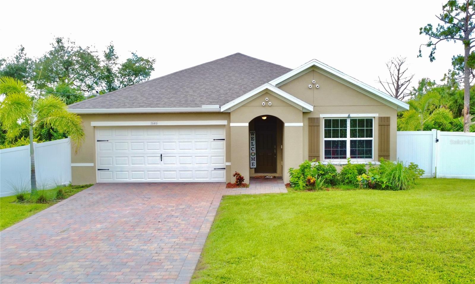 Welcome to your dream home at 1646 Pierpoint Street in North Port! This stunning 2023 construction features 3 spacious bedrooms and 2 full bathrooms. The inviting layout boasts 1,672 square feet of heated living space, adorned with beautiful 18-inch tile flooring throughout the main areas and plush carpeting in the bedrooms.
The heart of the home is the modern kitchen, complete with 36-inch designer cabinetry, elegant Silestone countertops, and all appliances included, making it perfect for both everyday living and entertaining. Enjoy the seamless flow into the bright and airy living room/dining room combo, which is enhanced by smart home automation features.
Step outside to your paver driveway and lanai, where you can relax and enjoy the Florida sunshine. Energy-efficient features like low emissive windows and a full irrigation system ensure your home is both comfortable and cost-effective. With an attached two-car garage, there’s plenty of space for your vehicles and storage.
Situated in a peaceful neighborhood just minutes from the vibrant shopping and dining options in Port Charlotte, and close to the interstate for easy commuting, this home offers the perfect blend of tranquility and convenience. Don’t miss your chance to make this beautiful property yours—schedule a showing today and experience this exceptional home.