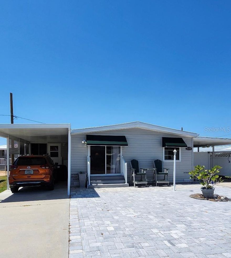 Dive into the good life! Here's your chance to own in a prime location near Sarasota Bay. Lots of upgrades throughout this two Bedroom, two Bath Mobile Home on a Lot & a Half in the highly desired, active 55+ Trailer Estates community. Beautifully updated kitchen with ample cabinet space and newer appliances. Spacious primary Bedroom with huge ensuite Bath and Laundry Room attached. 10x15 Bonus Room is currently used for sewing and crafts, but could be an office or third bedroom. New luxury vinyl flooring. All paver front, and two carports make it so convenient for your golf cart. 8x10 Shed. You own the land. Boaters have direct access to Sarasota Bay from the Marina. Trailer Estates community offers so many options for a great day! Enjoy the large, heated community pool, hot tub, gym and wood shop. The community buzzes with pickleball, shuffleboard, kayaking, horseshoes, bocce, dancing and more. A US Post Office on site. 10 minutes to the SRQ Airport. Convenient to shopping, restaurants, the Arts and everything in Bradenton/Sarasota. Bring offers!