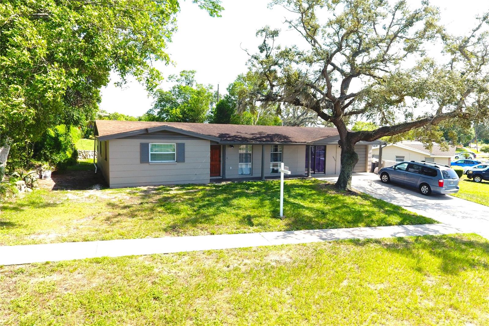 Beautiful Big House in Great Location on a Big Lot! Home with 3 BR / 2 bathrooms, plus an additional 4th bedroom or bonus room. The master bedroom can easily be converted into an in-law apartment. Features include a spacious family/Florida room, a large screened and caged patio, and a 1-car garage on nearly a quarter-acre lot. As you enter your new home, you'll find a bright and open living room followed by a dining area with new vinyl flooring. To the left is the updated kitchen with brand-new cabinets, new backsplash, newer stainless steel appliances and vinyl floors. At the rear of the home, a large Florida room (10' x 20') opens to a generous screened and caged patio (18' x 22') and a fully fenced backyard—perfect for gatherings or quiet evenings. Adjacent to the Florida room is the 4th bedroom or bonus room. From the entrance to the right is the master bedroom with an en-suite bath and shower, ideal for use as an in-law suite. To the left are two spacious bedrooms with cedar closets and a just updated bathroom with new tile, new vanity with a tub. Home updates include: AC (2019), roof (approx. 8 years old), fresh paint inside and out, newer windows in select rooms, and new blinds in several windows. No HOA, no CDD, and no flood insurance required! Come see it before it goes under contract!!