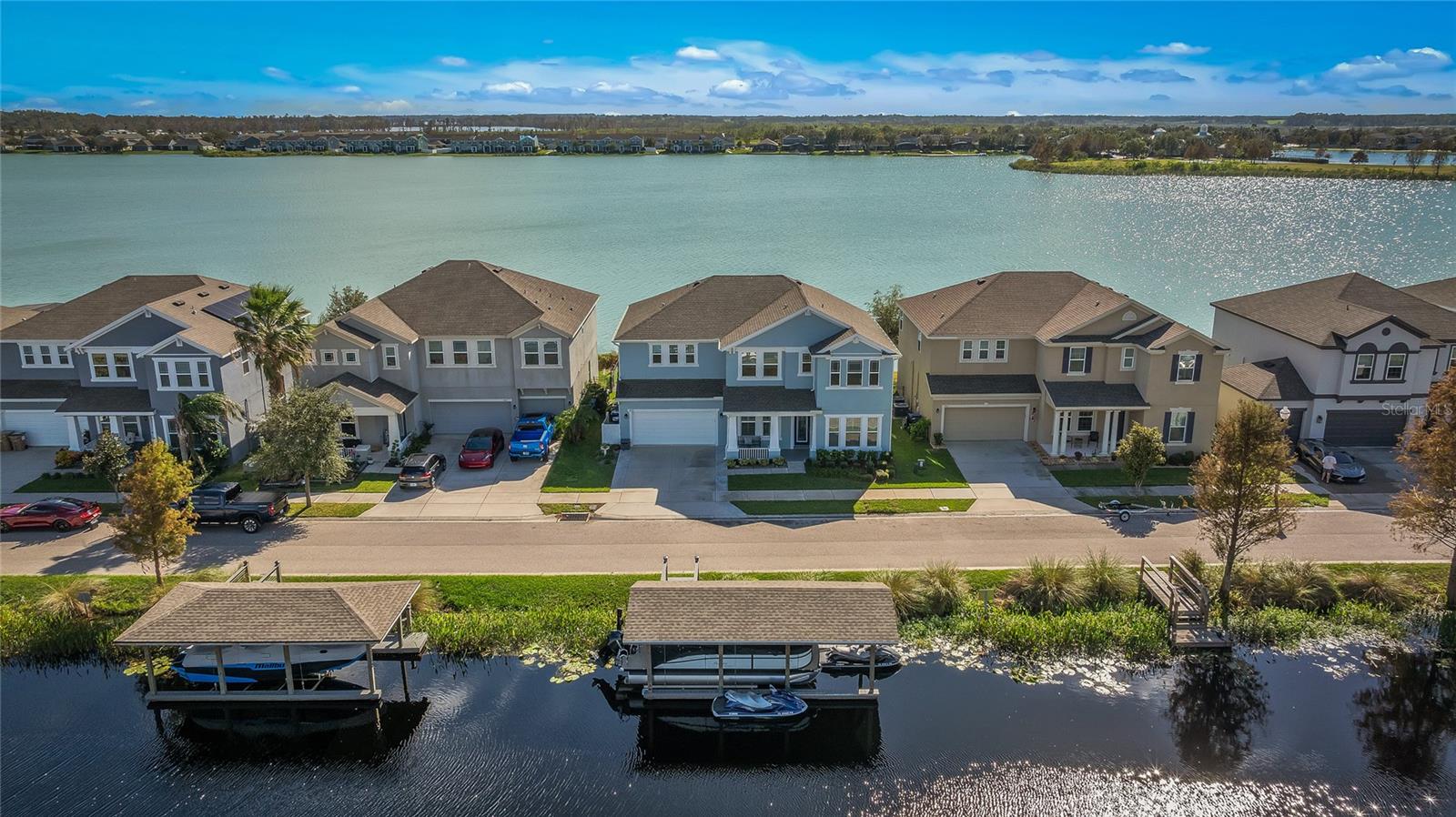 WATERFRONT HOME! This magnificent lakefront home with water views from all sides offers ultimate luxury living. Nestled amidst serene natural beauty, this property provides a tranquil escape from the hustle and bustle of everyday life. The spacious interior boasts five bedrooms and three and a half bathrooms, offering enough room for family and guests. The gourmet kitchen, a chef's dream, is equipped with top-of-the-line appliances and plenty of counter space, perfect for culinary enthusiasts. Including a recently added in-dry bar for top-tier entertainment space. The primary suite is a private oasis with a spa-like bathroom, a luxurious soaking tub, and a walk-in shower. The backyard provides a custom-built bar with a grill and a small wine cooler. The backyard is also covered in turf and custom pavers to allow a clean and neat look 24/7. Imagine sipping your morning coffee while gazing at the serene lake or hosting a party under the stars. In the front yard, the house offers a boat dock that was built in 2021 with a boat lift. Including a 3-car garage for all of your hobbies! The property's prime waterfront location offers endless opportunities for water activities, such as boating, fishing, and swimming. Whether you're seeking a peaceful retreat or an active lifestyle, this lakefront home has it all. Take advantage of this rare opportunity to own a piece of paradise.