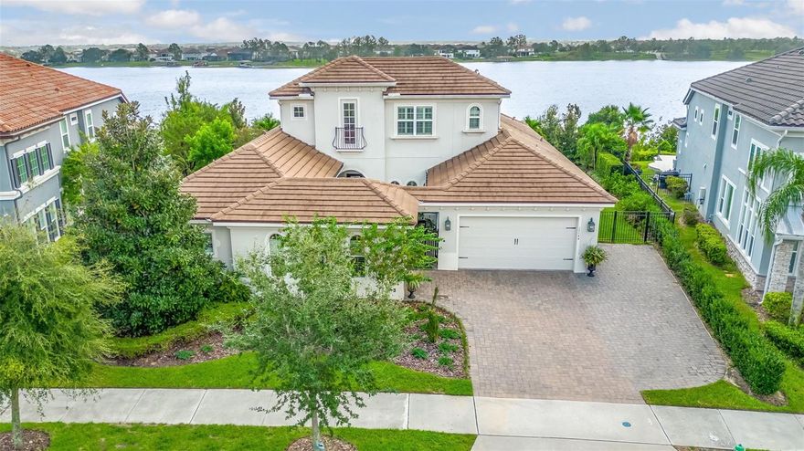 Luxury is a lifestyle in this Lake Hancock beauty! Sweeping views of skiable Lake Hancock by day, glowing shoreline lights and Disney Fireworks at night.  Every day is a celebration!  Over 4,000 sq ft in the coveted Cove at Overlook in the Hamlin community.  Boasting 4 bedrooms, a dedicated office, bonus room, 5 full bathrooms and a 3 car garage, this home has the perfect layout.

Enter the home through the gorgeous courtyard with magnificent custom concrete, gas fireplace making it the perfect gathering spot for conversation or a cozy spot outside on a chilly evening. Pass through the front door into an expansive open-concept room with immediate views of the luxurious pool and Lake Hancock.  Formal dining to your right and straight ahead into the family room and kitchen with eat in area flooded in natural light.  The enormous kitchen island features a farmhouse sink and flecked quartz counter that gently refracts light giving off an elegant, subtle sparkle.  The double stacked cabinets above the designer glass back splash, allow for extra storage and display opportunities while any entertainer will delight in the GE Monogram kitchen appliances that include an oversized 42” built-in refrigerator, 36” gas cooktop and french door, built-in wall oven.  The family room features 12’ tray ceilings with crown moldings galore and there is a whole house audio system for inside and out.  

The master suite has been enhanced with an extra large sitting area with views of the lake making it the perfect owner’s retreat when a little privacy is essential.  The spa like master bathroom offers a gorgeous glass tile walk-in shower, dual vanities, oversized soaking tub and custom closets with a separate back entrance to the laundry room.  

A short walk down the back hallway leads to the dedicated office and another bedroom with ensuite bathroom.  On the opposite side of the home you will delight at the oversized secondary bedrooms each featuring it’s own vanity and a shared jack and jill tub / shower area. The pool / guest bathroom is conveniently located making it perfect for easy access from outdoors or can be used as a bath for a bedroom. 

Not done yet…… There is a giant upstairs bonus room with it’s own full bathroom and large storage closet. 

The energy efficient windows are adorned with plantation shutters. Wood floors and designer glass tile and quartz counters in every bathroom are among the additional upgrades to this elegant, yet inviting home. 

The oversized salt water pool offers fiberoptic lighting, a sun shelf and spa and 2 large fire bowls that are sure to impress. The multi-level travertine deck also boasts an additional extra-large fire bowl perfect to sit around on those cool winter evenings. 

The professionally landscaped yard has been thoughtfully designed to maximize privacy and features landscape lighting creating the feel of a tropical paradise.  Sit on the deck and admire the Disney Fireworks at the end of the day.  What could be better?

The Overlook at Hamlin offers a resort style pool and splash pad, clubhouse with fitness center and a community dock. Hamlin is located near major highways, theme parks with easy access to first-rate hospitals and medical care, world class dining, shopping and golf courses. Bring your most discerning buyers.