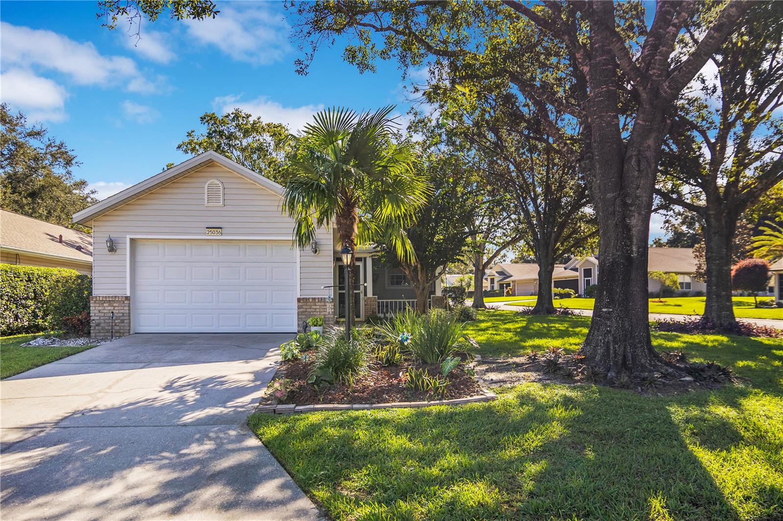 Welcome to this charming 2-bedroom, 2-bath home located in the highly sought-after 55+ community of Plantation at Leesburg. This beautifully maintained residence features an open floor plan with high ceilings, a spacious living room, and a dining area that flows seamlessly into the kitchen with breakfast bar seating. The master suite offers dual sinks and a walk-in closet, while sliding glass doors lead to a relaxing screened-in porch overlooking the corner lot. Recent updates include a new roof (2020), ceramic tile and engineered hardwood flooring, and fresh finishes throughout. Enjoy resort-style living with amenities such as two golf courses, three clubhouses, swimming pools, tennis and pickleball courts, walking trails, fitness centers, and an onsite restaurant. Conveniently located near shopping, dining, and medical facilities, this home is move-in ready and perfect for year-round or seasonal living.