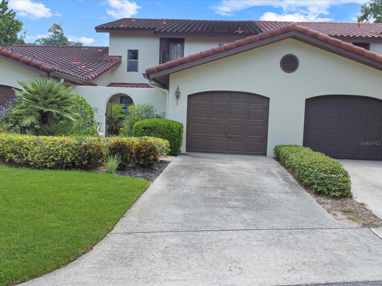 A refreshingly clean, neat as a pin and tastefully UPDATED townhome in a premiere area of GRENELEFE called CLUB ESTATES. The two VERY large bedrooms are both considered Primary bedrooms .... each with it's very own en suite bathroom. But first.....walk up the path thru the iron gates, past the delightful Key Lime tree, and gorgeous flowers and shrubbery to the front door of your new home. Once inside feast your eyes on the soaring Cathedral ceililngs over the main living area of this home. Then, the heart of this home...the Kitchen is outfitted with corian countertops and a gorgeous undermount kitchen sink, all tasteful and matching light fixtures, beautiful SS appliances and microwave built in above the range. A fashionable tiled kitchen backsplash plus under cabinet lighting to lend ambiance to this area of the home. Going to the dining room enjoy the expase of it all. The Living room with ceiling fan and wide open sliding glass doors to gaze into the rear yard of this home. The patio outside the tiled lanai is oversized and made of pavers. There is a Golf cart garage to either house your golf cart or it can be used for storage. Back inside walk to the first primary bedroom and it's delightfully remodeled en suite bathroom. Talk a few steps up the stairs to the loft area that often times get's turned into a third bedroom. Then take a look at the sedond primary bedroom and second en-suite bathroom. What's not to love ?? Although all this is too good to be true.....what if I told you this delightful home comes FULLY FURNISHED ??!!!!! YES IT DOES !! What you see in these pictures is what you get. Bring your p.j's and slippers, and move right in !! Hurry, this gorgeous townhome won't last long !! Call today for YOUR private showing !!