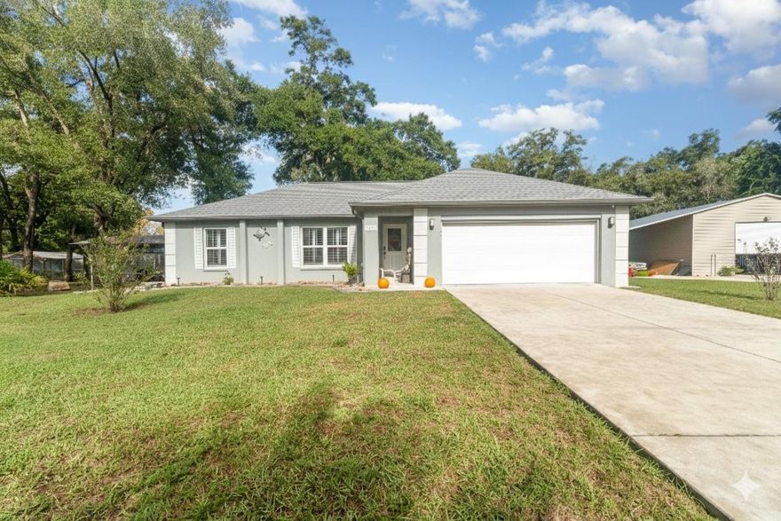 Welcome to 19063 Saint George Drive, Dunnellon, FL — a 2021-built home combining style, function, and space! This 3-bedroom, 2-bath residence sits on a 0.69-acre lot with premium upgrades throughout. The kitchen features granite countertops, upgraded cabinets, and an open layout that flows perfectly into the dining and living areas.
Enjoy tile flooring throughout, LeafFilter gutters for low-maintenance living, and a large fenced yard ideal for privacy or pets. The property also includes a spacious workshop that can fit a large RV, serve as a work or entertainment space, and comes equipped with EV/RV hookups.
Located just 0.8 miles from Blue Run of Dunnellon Park, you’ll be minutes from kayaking, nature trails, and the stunning Rainbow River — while still close to shopping, dining, and local conveniences.(Pet on premise Appointment only )
Move-in ready and built for comfort — this home truly has it all!