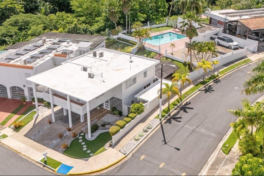 Experience refined living in this elegant two-story home located within the private gated community of El Remanso in San Juan. Set on a 875m2 lot, the property offers five bedrooms and 3.5 bathrooms, blending comfort, privacy, and timeless character.
The interior features bright open spaces, a functional kitchen ideal for gatherings, and a smooth transition to outdoor living areas that invite relaxation and entertainment.
The outdoor area is designed for enjoyment and leisure, featuring a swimming pool, terrace, landscaped garden, and a private basketball court. A separate service room with full bathroom provides versatility for live-in staff, chefs, or guest accommodations, enhancing the property’s convenience and value.
Built with solid concrete construction and carefully maintained, the home reflects lasting quality and thoughtful design. El Remanso offers security, tranquility, and proximity to major roads, schools, and shopping centers, making it a rare opportunity to own a distinguished residence in one of San Juan’s most desirable neighborhoods.
CRIM: $3,413 annually