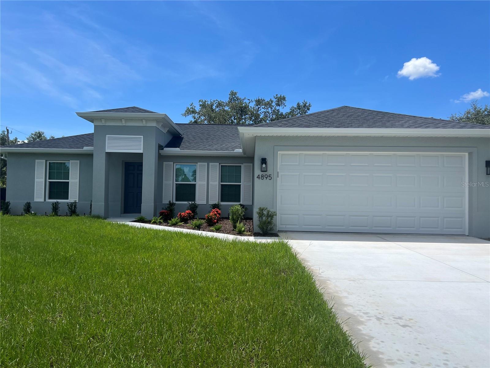 One or more photo(s) has been virtually staged. **ANNUAL**BEAUTIFUL 3/2/2 NEW CONSTRUCTION HOME AVAILABLE NOW**NEW VINYLE FENCE BEING INSTALLED SOON** Home has an open, split floor plan with vaulted ceilings, porcelain tile throughout, and sliding glass doors leading to large screened lanai. Gorgeous kitchen with full overlay cabinets, stone countertops, stainless steel appliances, and breakfast bar. Large primary bedroom has walk-in closet and ensuite with dual vanities. Indoor laundry room has cabinets for extra storage and utility sink. Home also has hurricane impact windows, ceiling fans, sprinkler system, and large corner lot. Conveniently located to shopping and restaurants. Call for showing today!!