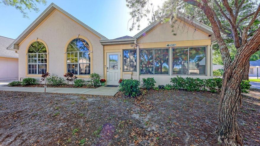 Designed in a refined Coastal Contemporary style, this beautifully updated in 2023/2024 3-bedroom, 2-bath split-plan villa showcases clean architectural lines, soft custom designer tones, and high-end finishes throughout. Every space reflects a cohesive, curated aesthetic with subtle sophistication.

Situated on a desirable corner lot, the expansive, air-conditioned Florida room is lined with a dramatic wall of windows, filling the home with natural light. Custom Levolor Zebra remote-operated shades provide effortless light control while maintaining a sleek, modern look.

Throughout the living areas and bedrooms, classic wood plantation shutters add timeless elegance and privacy. New A/C 2025.

The heart of the home is the oversized, light-filled kitchen—ideal for both everyday living and entertaining—featuring newly refinished 42-inch cabinetry with updated hardware, abundant storage, new countertops, and enhanced overhead lighting. A thoughtfully designed prep area flows seamlessly into the dining and living spaces, where soaring vaulted ceilings and a cozy wood-burning fireplace create a warm yet open atmosphere perfect for gathering.

New luxury vinyl flooring extends throughout the home, offering a clean, modern aesthetic with durability and ease of maintenance.

With intentional upgrades, abundant natural light, and a designer’s touch in every room, this home delivers effortless style, comfort, and functionality.  The location, amenities, and charm of the neighborhood make this home a joy to see in person.