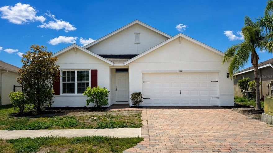 Welcome to this beautifully maintained 4-bedroom, 2-bath home located in the gated community of Marblebrook. This home features a brick paver driveway and entry, fresh interior and exterior paint, a NEW ROOF, pond views from the living room, dining area, and primary bedroom, and is not located in a flood zone.

The open kitchen overlooks the living and dining areas and includes a center island with sink, bar seating, walk-in pantry, and brand-new stainless steel appliances including a side-by-side refrigerator. Tile flooring runs throughout the main living areas, with brand-new carpet in all bedrooms.

The primary suite includes dual sinks, a walk-in shower, private water closet, large walk-in closet, and additional bathroom storage. Additional features include an inside laundry room, blinds throughout, hurricane shutters in the garage, and a brick paver patio overlooking the pond.