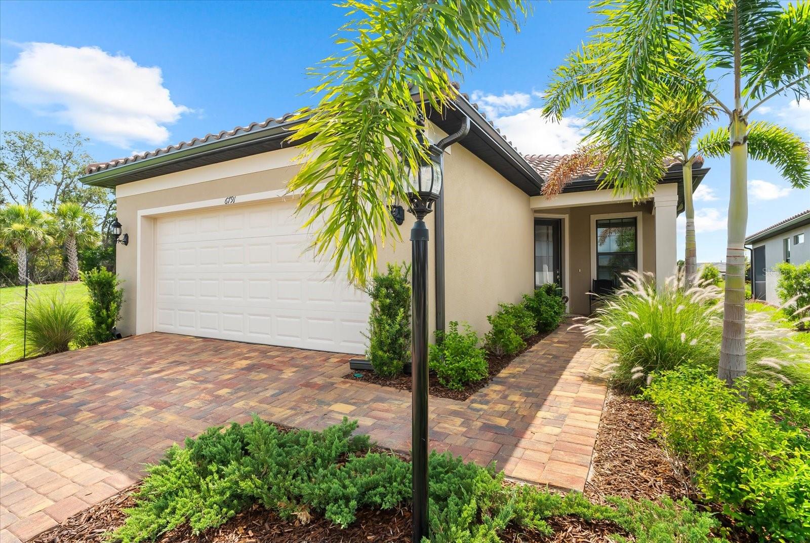 Skip The Wait – Step into Luxury!
Why build when you can move right into this beautifully upgraded, 1,405 sq ft Pulte Contour Model, ideally positioned at the end of a quiet street on an oversized side yard with serene water views—all within Del Webb at Lakewood Ranch, the premier 55+ community in the nation’s #1 multi-generational master-planned development.
This stylish 2-bedroom, 2-bath home with a den, 2-car garage, and extended lanai offers a perfect balance of modern luxury, thoughtful functionality, and effortless Florida living.
From the moment you arrive, you’ll be impressed by the immaculate condition and inviting curb appeal of this move-in ready home. Inside, you’ll find Bali window coverings, neutral ceramic plank tile flooring throughout, soaring ceilings, 8-foot 2-panel interior doors, 5 ¼ baseboards, and upgraded recessed lighting, creating a bright and contemporary atmosphere.
The heart of the home is the fully upgraded gourmet kitchen, equipped with 42” light cabinetry with soft-close drawers and double pull-out trays, KitchenAid stainless steel appliances including an upgraded French Door refrigerator, gas cooktop with a custom wood canopy hood, quartz countertops complemented by a striking mosaic tile backsplash, large island with seating for three an ample prep space—perfect for entertaining or casual meals.
Wake up to peaceful water views from your spacious owner’s suite, which features a luxurious ensuite bath with dual sinks and quartz vanity, oversized walk-in shower with floor-to-ceiling tile, custom walk-in closet with built-in drawers and shelving for ultimate organization.
The additional bedroom, thoughtfully placed for privacy, also features a custom closet and is adjacent to a stylish bathroom with a floor-to-ceiling tiled walk-in shower and pull-out wire shelving under the sink. The versatile den offers the perfect space for a home office, reading room, or hobby space.
Step out onto the extended lanai, complete with ceiling fans and ample room for relaxing or entertaining—all while taking in tranquil water views.
Additional features and recent upgrades include epoxy garage floor, water softener and filtration system with purifier and reverse osmosis, recently pressure washed and sealed driveway, walkway, and lanai—truly move-in ready.
Treat yourself to the lifestyle you deserve. Del Webb at Lakewood Ranch offers an unmatched active adult lifestyle with resort style amenities, social clubs, and a vibrant community atmosphere.
Don’t miss your opportunity to own this exceptional home in one of Florida’s most desirable communities. Schedule your private tour today!