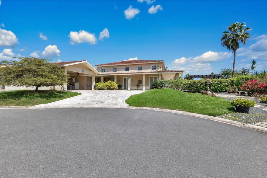 Located in Sabanera Dorado, Puerto Rico, this expansive Casona Carbia residence features four bedrooms, three full bathrooms, and a powder room, spanning 6,300 sqft in total, with 4,300 sqft of refined living space.
 
The property features high ceilings and thoughtfully designed living spaces, including a mezzanine, great room, family room, dining area, and outdoor lounge with exquisite marble floors throughtout.
 
Privately situated at the end of a cul-de-sac, the property offers a serene retreat with a sparkling pool surrounded by lush landscaping. Equipped with solar panels for enhanced energy efficiency. Located within a gated golf cart community, residents enjoy resort-style amenities, including community pools, a gym, tennis and basketball courts, as well as a convenience store, the renowned TASIS school, and 24/7 security.