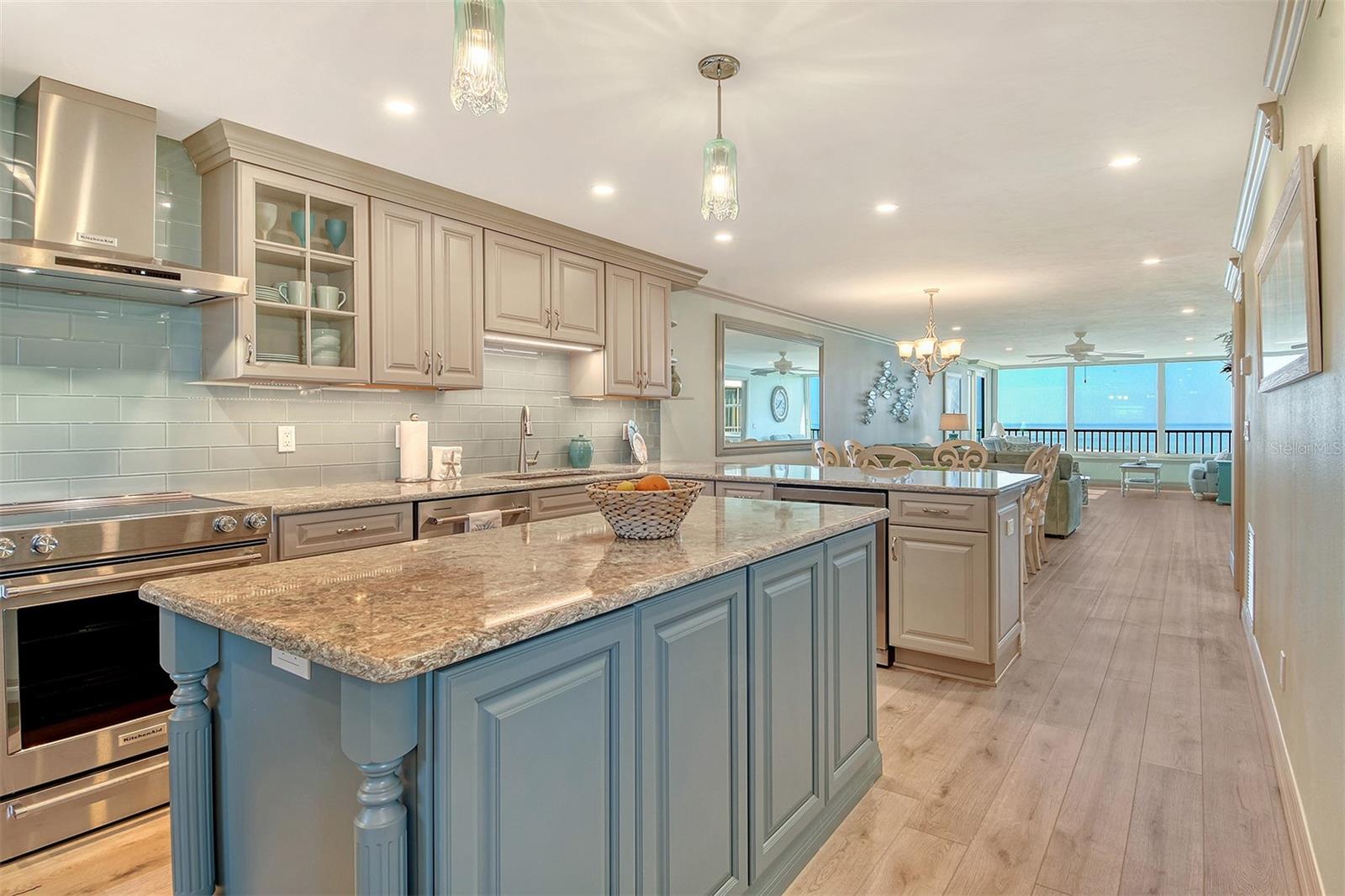Knock, knock your slice of paradise is calling! There’s no place like this home or home away from home! A gorgeous view in an exquisitely updated condo on the world’s finest beach! What more could you ask for?!! HURRICANE WINDOWS, Quartz countertops EVERYWHERE (even in the laundry room!), wine refrigerator, Kitchen Aid appliances, new cabinetry (including in the bathrooms), closet built-ins, luxury vinyl plank flooring, tasteful, coastal furniture, electronic remote control Hunter Douglas shades on windows, ample storage, full size utility room, enclosed balcony professionally done so it truly feels like part of the home. Being sold furnished with everything you need to get started living the good life! The Gulf & Bay community is packed with amenities and spacious grounds, located mid-key with easy access to the north or south bridge, with a guarded gate and on-site property management, you will not be disappointed! 4 Tennis (3 Plexi cushion, 1 clay), 6 pickleball courts, and 2 racquetball courts, shuffleboard, a fitness room and clubhouse with a library, computer and meeting/event room and card room. The common area and multiple pools are lushly landscaped and manicured, giving you that true resort feel. The parking lot is pavered and carports, with deeded parking spaces, are included with units as well as ample guest spaces. There is also a carwash area and there are electric vehicle charging stations. Building E has the advantage of being closer to the water and therefore a more up-close view of the Gulf. Click your heels together and power up that hot air balloon (or whatever mode of transport you prefer) and hurry over to follow your heart and mind and gather the courage to grab your slice of paradise before it’s gone! This is not a dream, it’s a dream come true!