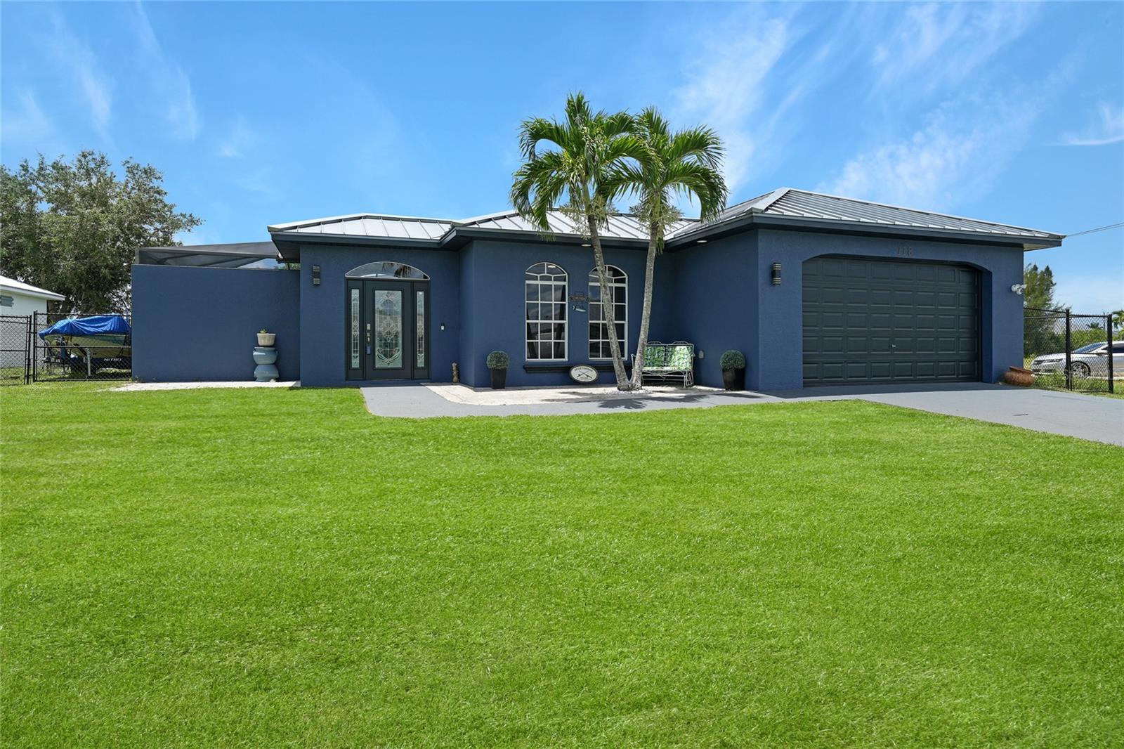 Welcome to 118 21st Terrace, Cape Coral, FL 33991—a beautifully designed 3-bedroom, 2-bathroom courtyard pool home that offers the perfect balance of comfort, style, and Florida waterfront living. This well-maintained residence has been thoughtfully updated with a long list of improvements, including a NEWER metal roof (2023), NEWER A/C system, NEWER hot water heater, NEWER pool cage, and hurricane shutters on all windows and doors, providing peace of mind and long-term value. With 2,223 square feet of living space and a spacious 2-car garage, this home features a light-filled, open floor plan ideal for both entertaining and everyday living. The interior is enhanced with elegant crown molding, tray ceilings, and tile flooring throughout, creating a sense of sophistication and flow. At the heart of the home is the fully remodeled kitchen, which showcases a large granite-topped island, stainless steel appliances, custom cabinetry, and tasteful finishes that will impress even the most discerning cook. The unique courtyard design centers around a private pool area that feels like your own personal resort—perfect for sunbathing, swimming, or relaxing with friends and family in total privacy. The split-bedroom layout offers excellent separation and privacy for guests or family members, while the open-concept living and dining areas bring everyone together in comfort and style. Step through to the rear of the home and you’ll find a beautiful wood dock with canal access, offering a direct connection to Cape Coral’s sought-after waterfront lifestyle. Whether you enjoy boating, kayaking, paddleboarding, or simply watching the sunset over the water, this home delivers the ultimate outdoor experience right in your backyard. Perfectly located near shopping, dining, parks, and major roadways, this move-in ready property is not only a home—it’s a lifestyle. With all the major upgrades already done, 118 21st Terrace is your chance to own a slice of paradise in one of Cape Coral’s most desirable areas.