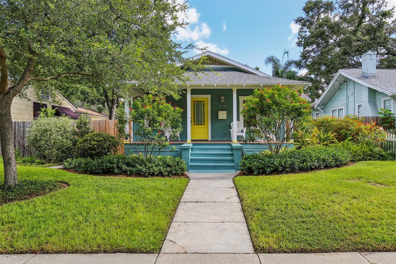 Welcome to 3135 6th Ave N, a bright and beautifully updated 2-bedroom, 1-bath 1932 bungalow located in the heart of Historic Kenwood, one of St. Petersburg’s most celebrated creative neighborhoods. As part of the official Historic Kenwood Artist Enclave, this property is more than just a home. It’s a place where you can live, work, and legally create or sell your art from your residence.
Start your day on the inviting covered front porch, the perfect spot for morning coffee or a quiet evening under the canopy of this walkable, tree-lined neighborhood. Inside, you’ll find hardwood floors, UV-tinted windows that let in soft, filtered light, and a cozy wood-burning fireplace that anchors the entry room. A Nest thermostat, modern ceiling fans, new light fixtures, and a fresh coat of paint bring smart, stylish comfort to every room.
The kitchen has been tastefully renovated with stone countertops, new appliances, vented cook-top, in-sink disposal, soft-close doors and drawers, and crisp white cabinetry. The bathroom retains its classic black-and-white charm, updated with clean fixtures and plenty of built-in storage. The primary bedroom features dual lighted wardrobes to meet your modern storage needs. The home also features a tankless water heater, providing energy-efficient hot water on demand.
Out back, a fully fenced yard with lush landscaping, gas grill, and pergola-topped deck offers the perfect space to relax or entertain. The detached garage functions as a well equipped workshop, ideal for woodworking, a home studio, or creative business space.
With zoning that supports artist-focused use, a move-in-ready interior, and a location just minutes from the Grand Central District and downtown, this is a rare opportunity to own a home that supports both your lifestyle and your work.