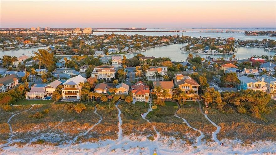 Have you been dreaming about a beach house?  This quaint elevated home is truly a slice of paradise with the sounds of waves crashing in the distance.  Walk right out the door and down your private path to the sugary sands of the Gulf of Mexico and St. Pete Beach.  The main house with abundant natural light is a two bedroom one bath.  The home is elevated and charming with white pecky cypress walls, high ceilings, an open floor plan and an updated large bathroom.  The kitchen is open and airy and holds space for eating in.  The best place to relax, however, is on the large deck facing the beach with plenty of room for a dining table, lounge chairs or sunning chaises.  Downstairs is a separate one bedroom, one bath garage apartment, storage room with laundry and under building spot for shaded relaxation and storage for bikes, kayaks, grill and an outdoor shower.  The value here really is in this unique and special beach location.  Take advantage of this rare opportunity to live your salty, sandy dreams.  Building options, plans and renderings may be available if interested.