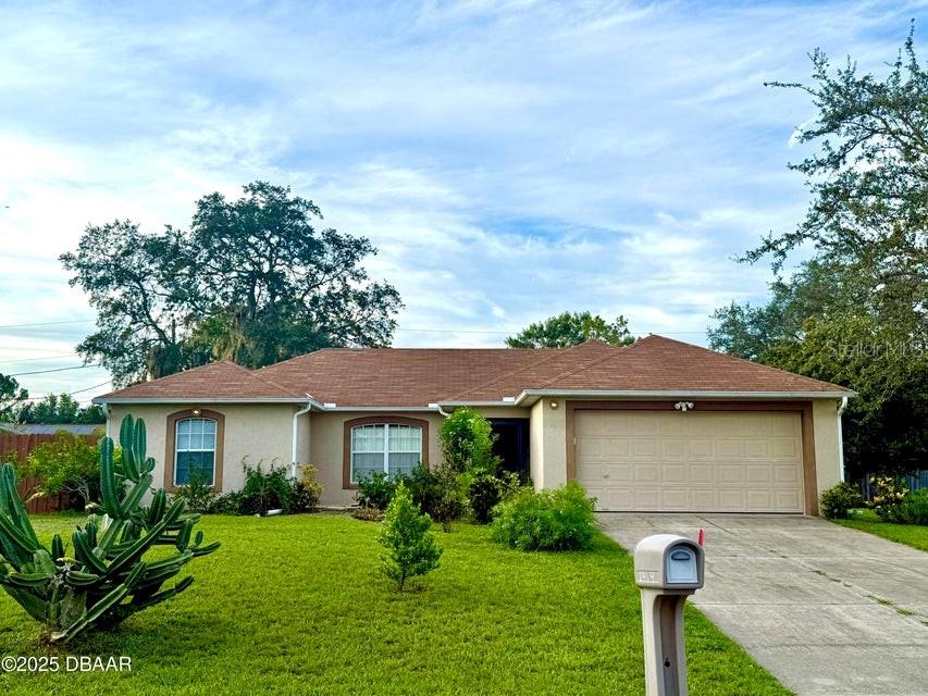 Welcome to your next beautiful home, well maintained 3 bedroom, 2 bath with large backyard and garden with peaceful ambiance and tranquil neighborhood. No flooding has ever occurred on this property. This beautifully designed split floor plan offers both comfort and functionality. Step inside to find high vaulted ceilings and solid tile surface flooring throughout the home, creating an open and airy ambiance. This property has been gently maintained with lots of love and care. Back porch has been renovated to enjoy both indoor and outdoor ambiance. Full size garden offers a large rose garden, papaya tree, lemon/lime trees and more! Perfectly located for comfort of living and close range to both the beaches and Orlando. Don't miss out on making this beautiful property your next home!