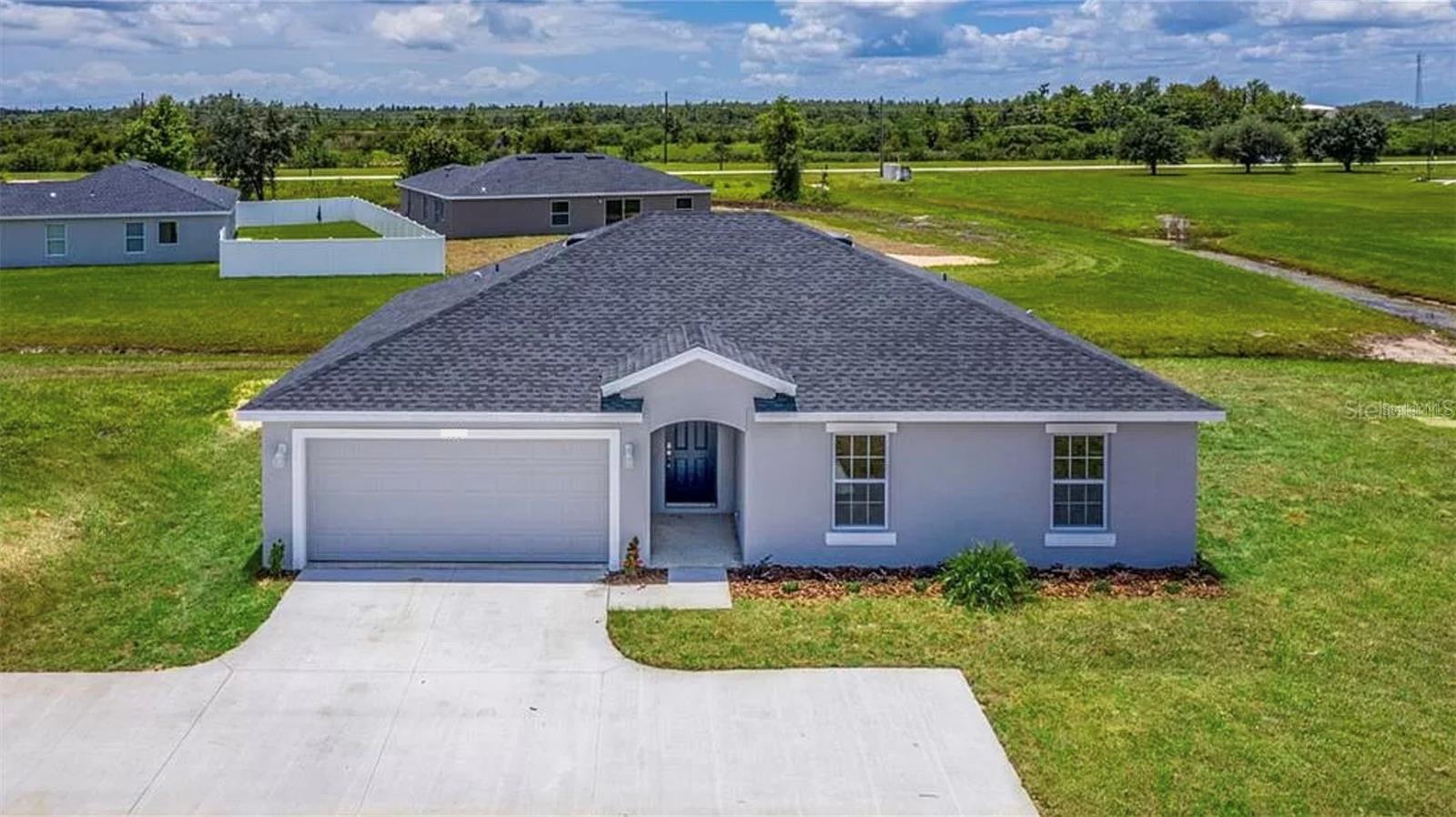 Boasting many upgrades, this home includes beautiful granite countertops, a spacious kitchen island, and 42" slow-closing cabinets, all accented by top-of-the-line stainless steel appliances. The 5" baseboards and ceramic tiled floors lend an air of elegance to the home's interior. The master bedroom and tiled master bathroom feature his and hers sinks with granite countertops, while the expansive private driveway accommodates up to 6+ vehicles situated on your very own private flag lot. Don't miss your opportunity to make this beautiful home yours!