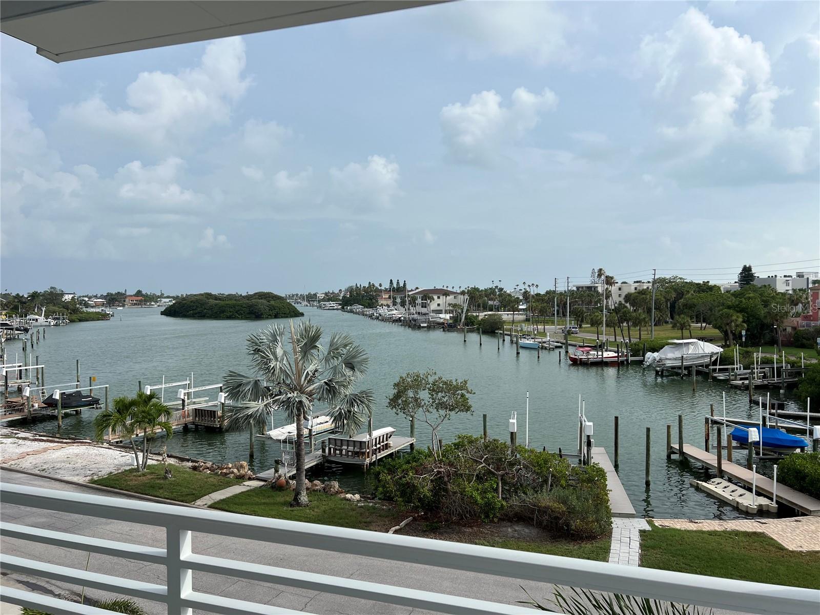 Nice southern water views! Pass A Grille Beach and the Historic Don Cesar Hotel are right across the street from this custom built waterfront FEMA compliant home equipped with a heated saltwater pool and spa in the oversized private backyard! Features like a sun shelf, bubblers, massage jets, deck jets and multicolored lighting all controlled with your smart device…Not to mention putt putt golf, turf yards, coconut palms and one banana tree will make for the ultimate pool party! The private dock has a 13,000lb boat lift, Azek composite boards with electrical and a water supply. Double garages with oversized insulated doors with brand new polyaspartic floors. Now let’s go inside! This open floor plan has 10ft Ceiling heights throughout 2nd and 3rd levels, 8ft header heights for ALL doors and windows, The spacious kitchen comes with high end custom maple cabinetry featuring dove tail, soft closing drawers, glass faced doors and hidden led lights accentuating the glass backsplash. It is open to the living and dining rooms and overlooks both the front and back of the house, all from the kitchen sink! This expansive eat-in island has a comfortable kitchen table feel, as you entertain and prepare at the same time. Complete with durable Pompeii Quartz and Thermador Appliances. The primary suite resides on the 3rd level covering the entire front of the home, capturing the gulf/water views. 4 spacious covered balconies ensure comfortable indoor/outdoor living. CaliBamboo Engineered hardwood floors throughout home, that have a limestone composite foundation, giving them more of a water/scratch resistance, so you can enjoy the fun beach living with low maintenance floors. The elevator to all 3 levels is centered in a wrap around “Stair Tower”. Laundry/pantry rooms are on both the 2nd and 3rd levels. Every ensuite bedroom has it’s own bathroom, walk-in closet with custom shelving, and balcony access. Quick access to I-275 that will take you to Downtown St Pete in less than 10 minutes or Tampa International Airport in 30 minutes.