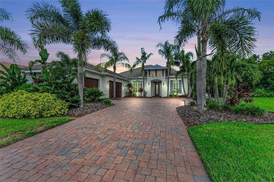 Tucked away on nearly a half-acre, this custom Bruce William's built residence offers both privacy and an abundance of nature with serene conservation and pond views. Originally presented as the builder’s model home, it showcases their curated design selections and refined finishes, found in abundance throughout.

With its pavered driveway, side-load 3-car garage, and private homesite overlooking the pond, the residence makes a grand and welcoming first impression. Inside, you’ll find 3,133 sq ft of living space with 3 bedrooms, 2.5 baths, a den/office, bonus room, and a spacious great room layout. The primary suite is a true retreat, featuring 2 walk-in closets and a spa-like bath with a soaking tub. The gourmet kitchen is a standout with Thermador & Bosch appliances, gas range, custom cabinetry, and a mix of granite and quartz countertops. Hardwood floors, custom trim details and plantation shutters add to the home’s elevated character while impact windows and doors throughout provide peace of mind. Your outdoor retreat awaits with a sparkling pool, Travertine lanai, and a covered living area complete with fireplace, perfect for entertaining or simply unwinding in the serene ambiance. Set within Winding River, a boutique community of just 62 homesites on the banks of the Manatee River, residents enjoy access to a private boat launch to the Manatee River, nature trails, and a picnic area. Enjoy maintenance-assisted living with lawn care and irrigation provided through the HOA, plus the added benefit of no CDD fee.