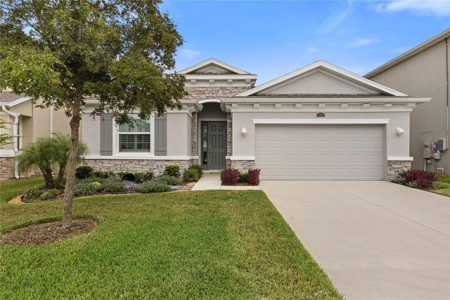Immaculate move-in ready Lantana model 4-bedroom, 2.5-bath west-facing home with a peaceful pond view in the highly desirable community of The Preserve. Built in 2022, this beautifully maintained home features an open split-bedroom floor plan with elegant plantation shutters, upgraded lighting, and plush upgraded carpet. The gourmet kitchen includes granite countertops, a large island with seating, upgraded stainless steel appliances, upgraded cabinetry, and a walk-in pantry. The primary suite offers a tray ceiling, dual walk-in closets, and a luxurious ensuite bath with dual vanities, granite counters, a soaking tub, and a walk-in shower. The laundry room comes equipped with an LG washer and dryer, and additional features include a 2-speed A/C system under warranty, a water softener, automatic retractable shades on the sliding glass door, and hurricane shutters for easy storm preparation. The fully fenced backyard overlooks a serene pond, perfect for relaxing or entertaining. Residents of The Preserve enjoy resort-style amenities including a clubhouse, heated pool and lap pool, fitness center, playground, and dog park, with convenient access to the Suncoast Trail—a 54-mile paved trail that runs alongside the Suncoast Parkway through Hillsborough, Pasco, Hernando, and Citrus counties—all just minutes from Publix, shopping, and dining.