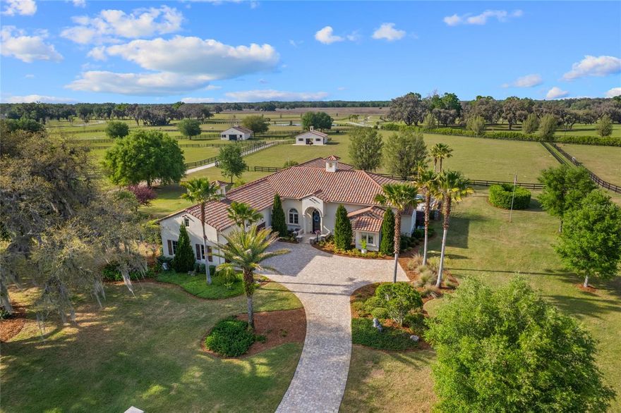 If you’re looking for a stunning equestrian estate in a gated community - look no further! This is an exceptional opportunity in Bel-Lago, one of Ocala’s premier lakefront and equestrian communities. This property boasts a luxurious Tuscan-inspired home, private paddock with a 2-stall center aisle concrete block barn, AND a separate buildable parcel package with additional paddock, equaling 9.25-acres in total. Built in 2018, this custom single-story pool home features 3 bedrooms + office, 4 full bathrooms, and a 3-car garage with upstairs room. Inside the home, you’ll find high ceilings all throughout, Travertine flooring, and unique finishes and fixtures. The kitchen showcases a striking granite piece for the center island, high-end appliances, custom two-tone wooden cabinetry, and separate wet bar. Enjoy the additional kitchen storage with your walk-in pantry, complete with an antique farmhouse sink! The cozy living room features coffered ceilings, built-in shelving, and a warming stone gas fireplace. Your private primary wing provides direct access to your pool deck, and a fabulous ensuite bathroom with dual walk-in closets, walk-in shower, dual vanities, and garden tub. Your two additional guest rooms both have spacious closets, ensuite bathrooms, and window fixtures for privacy. Watch your horses from the comfort of your lanai, complete with an outdoor grill space and gas fireplace, leading to your heated in-ground pool and spa, perfect for entertainment and relaxation. *This home is also linked to a whole-home Generac generator, providing peace of mind!* Your horses will love the charming 2-stall (12x12) center aisle barn, finished with a feed/tack room, hay room, and equipment storage (could be converted to foaling stall). Your paddocks are fully-fenced with automatic waterers, and provide direct access to the internal trail system. Enjoy your additional space with the extra land, or build on your adjoining homesite parcel as an investment opportunity. Bel-Lago is an exclusive lakefront and equestrian community uniquely surrounded by over 8,000+ acres of preservation. The community includes a gatehouse, multiple feature lakes, a multi-use internal trail system, and HOA. Enjoy your private oasis in Ocala horse country, while being minutes away from restaurants, grocery stores, and hospitals, 25 minutes to WEC, and only 1.5 hours away from Orlando and Tampa. Call today for more information!
