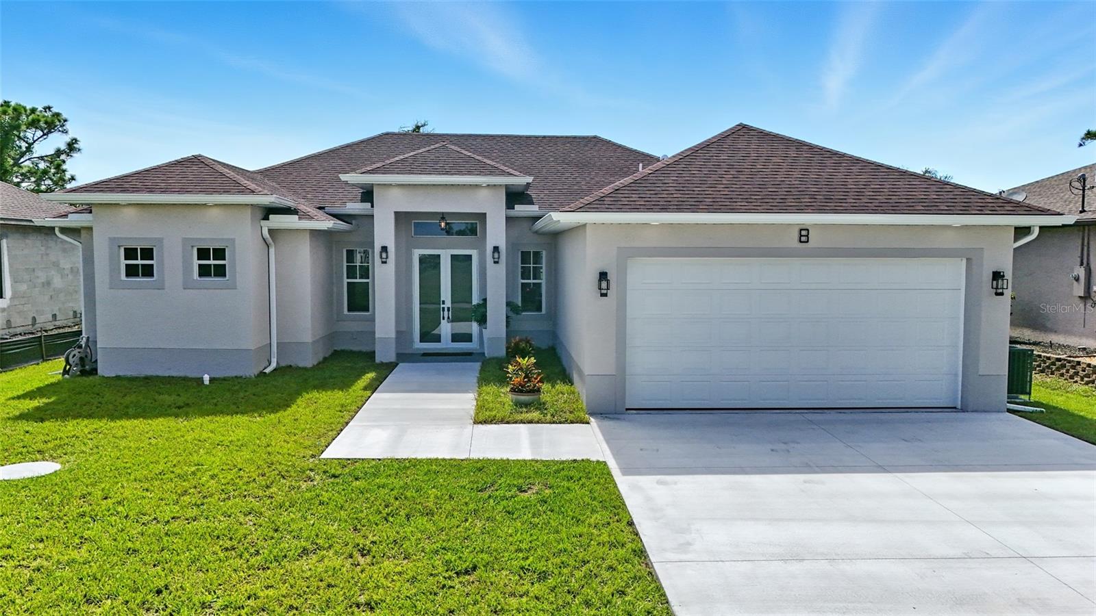 Welcome to your brand-new 3-bedroom, 2-bath home located in the desirable Rotonda Sands subdivision. This beautifully designed residence features a covered double-door entry leading into an open floor plan with tile flooring throughout, tray ceilings, and an abundance of natural light. The eat-in kitchen shines with a center island adorned with a tile accent, stainless steel appliances, backsplash, modern light fixtures, and luxurious gold finishes including a gold sink and cabinet handles. The kitchen opens up to a spacious dining area, equipped with large window. This open concept living area leads directly out to a covered, screened-in lanai—perfect for indoor-outdoor living. The primary suite offers a tranquil retreat with a spa-like bathroom that includes a large standing shower with modern tile and wood paneling, double vanity with gold fixtures, and a custom walk-in closet with built-ins. Additional features include a separate laundry room, hurricane-impact windows, and a lush backyard space. Rotonda Sands is a peaceful, deed-restricted community with scenic walking areas, lakes, canals, and greenbelts, located near Boca Grande and Englewood beaches, top-rated golf courses, and the Cape Haze Pioneer Trail. With low HOA fees and a serene, well-maintained setting, this home combines modern elegance with Florida’s laid-back lifestyle. You don’t want to miss this one!