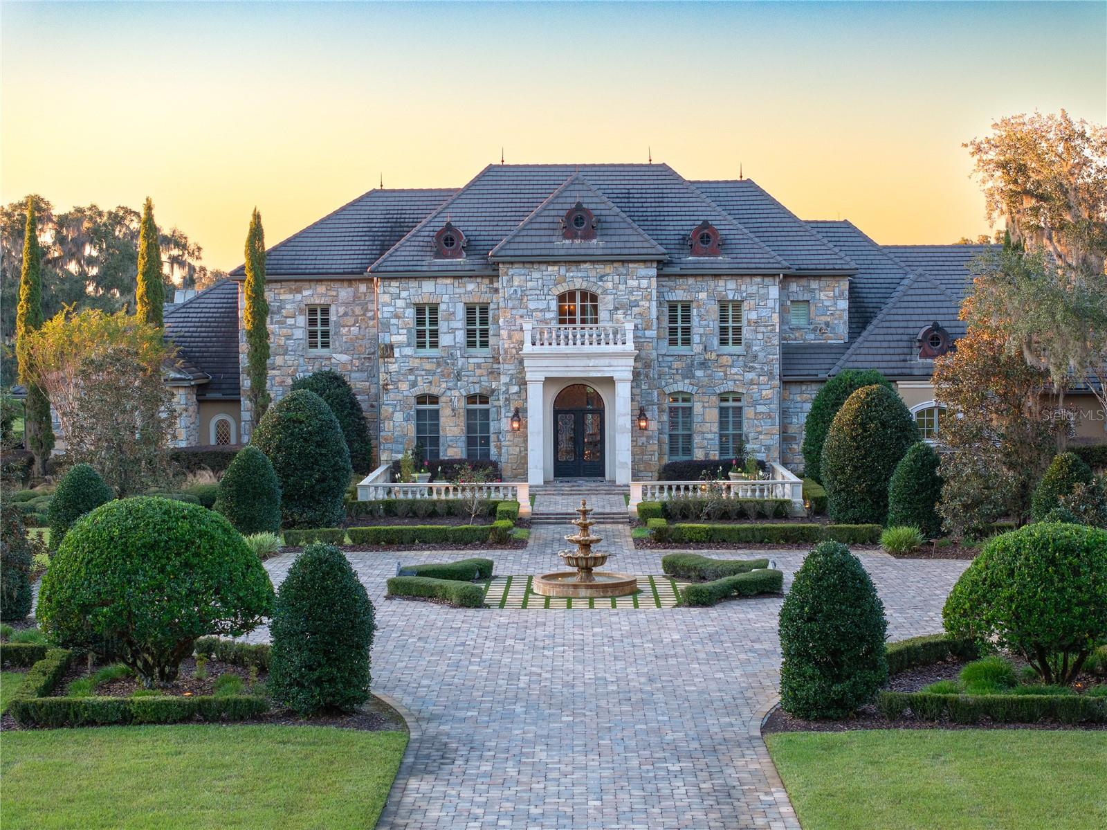 1935 +/- Acre Incredible French Country Estate offers peace, privacy, and the enjoyment of having your own hunting and fishing preserve. Lake Ledwith is 1,400 acres, of which 700 +/- acres are included in the sale of this property. Magnificent, professionally designed, and sculpted 7,918 SF 5-bedroom, 5.5 bath stone residence combines the best of elegance, style, and craftsmanship and offers gorgeous, expansive views of the surrounding Granddaddy Oaks and grounds. The foyer opens to a grand staircase, formal dining, and a large living room with a carved stone fireplace. Beautiful chef’s kitchen with hidden pantry, butler’s pantry, expansive center island, the bar seats five, and a separate family room with fireplace and family dining area. The open floor plan makes the home perfect for entertaining friends and family. French doors open onto expansive verandas with a summer kitchen, outdoor dining, and gathering areas around a double-sided fireplace overlooking an exquisite pool. Spacious owner’s suite offers a seating area, dual closets, and access to the pool. The incredible features that make this French home elegant and warm include Travertine floors, soaring architectural ceilings, impressive beam works, five fireplaces, and intricate moldings. Private office, exercise room, wine room, game room with beautiful beverage bar and seating area for watching games, planning your next duck, deer, or turkey hunt, or showing pictures of your 8- to 12-pound bass caught on your property. 1,200 +/- acres are perimeter fenced with 8-foot-high game fencing. In terms of privacy and security, this resort-like property is unsurpassed. 4- Car garage. Located just minutes from Williston airport.