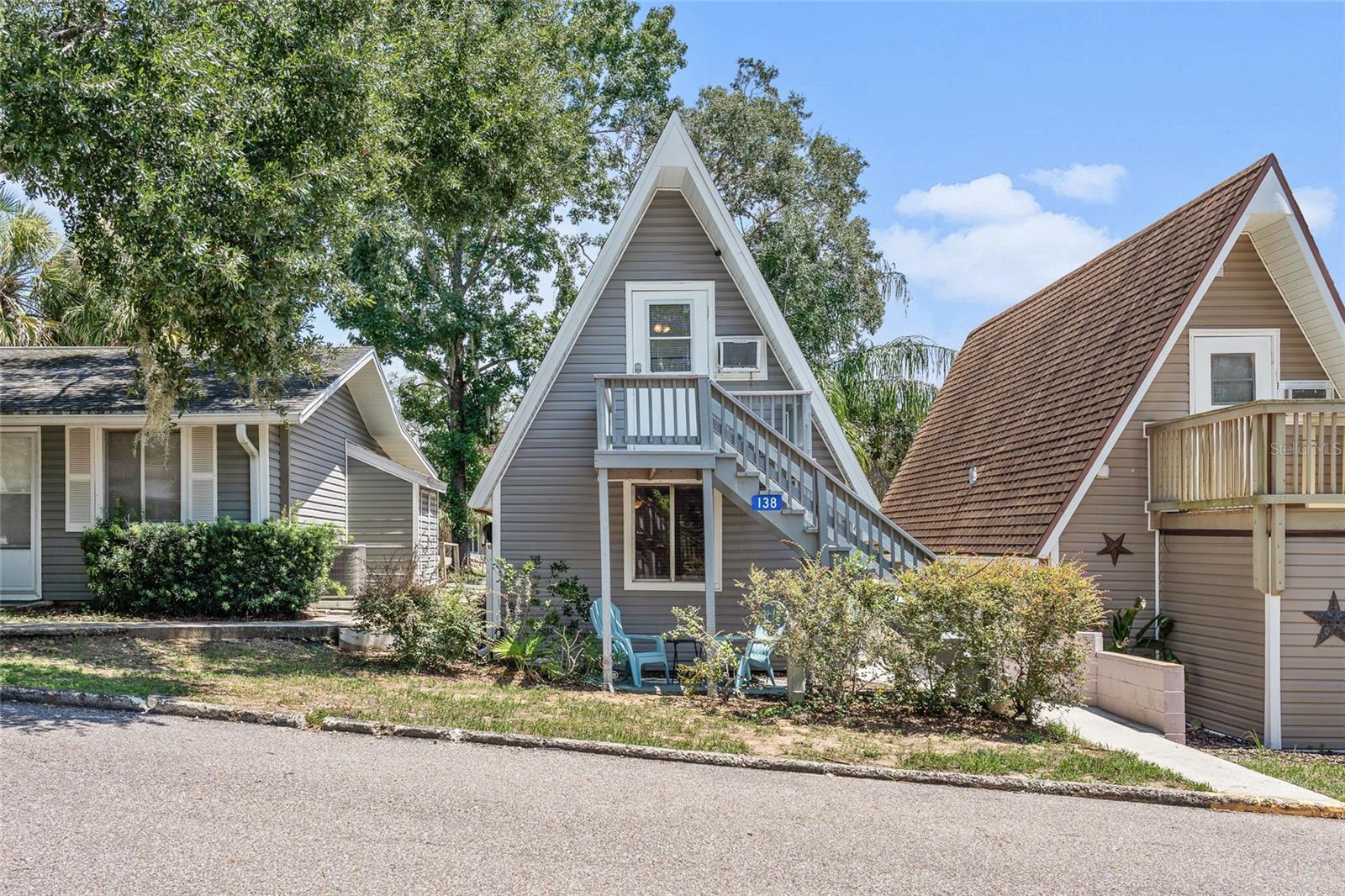 Welcome to this charming two-level A-frame condo, offering a unique blend of comfort, convenience, and character. Featuring 2 bedrooms, 1 bathroom, and a versatile loft bedroom, this home has been freshly updated with a newly painted interior, new laminate flooring, a modern kitchen sink and faucet, and a water filtration system. The home also boasts a brand-new roof with new gutters coming soon, plus a private deck off the second floor and small patios in both the front and back—perfect for relaxing outdoors. The seller has also already paid the Special Assessment of $2,309.60 for Re-roof of the common areas.
Inside, you’ll find classic wood paneling, a cozy spiral staircase leading to the loft, and bright, open living spaces. The HOA takes care of the big things—including exterior maintenance like the roof and siding, lawn care, cable, WiFi, water, sewer, trash, and access to community amenities—leaving you responsible only for electricity and property taxes.
Perfectly situated, this property is just 20 minutes from Walt Disney World’s Magic Kingdom, 25 minutes from Universal Studios, and only 15 minutes to downtown Clermont where you can enjoy the weekly farmers market and community events. With easy access to Hwy 27, Hwy 50, and the Florida Turnpike, you’ll also be close to Winter Garden, grocery stores, shopping, dining, and more.
This condo is ideal as a primary residence, vacation home, or investment opportunity in the heart of Central Florida!
The community offers an impressive array of amenities, including an Olympic-size swimming pool, tennis, pickleball, and shuffleboard courts, as well as basketball courts and multiple playgrounds. Residents also enjoy practical features such as a car washing station and an oversized fenced parking lot designed for RVs, boats, and extra vehicles. For lake lovers, the neighborhood provides private beach access on the Clermont Chain of Lakes, along with a community boat ramp and dock exclusively for Vacation Village owners and guests.