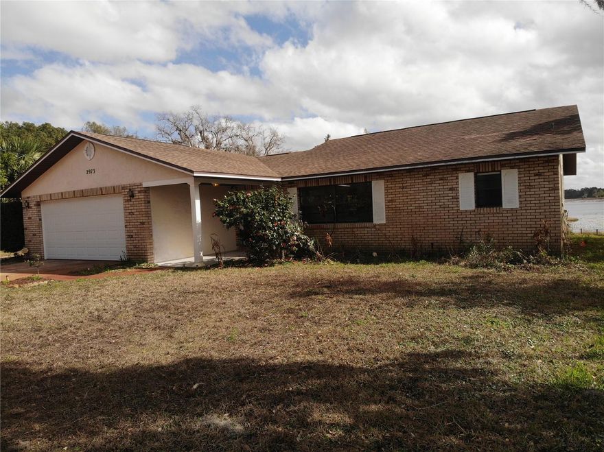 2/2/2 with a 1 car carport. 1,616 Sq ft. on nearly half an acre looking down the spine of one of the Three Island Lakes. Highlights include a 2017 Roof, a 2011 regularly serviced HVAC as well as two 10 x 8 outbuildings and a 314 sq ft. enclosed and tiled lanai with power hookups.