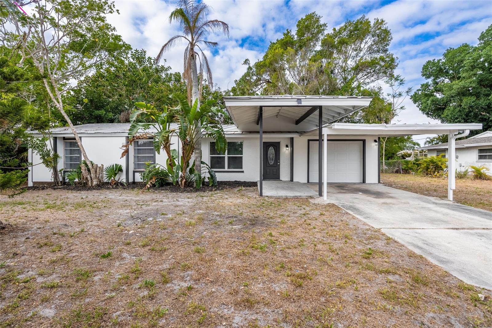 Welcome to this breathtaking, fully remodeled home tucked away at the end of a peaceful cul-de-sac in one of the most sought-after and centrally located areas—just minutes from Downtown Fort Myers, Cape Coral, excellent public schools, and beautiful local parks. Whether you're a first-time homebuyer, a seasonal snowbird looking for a winter retreat, or an investor searching for a no-hassle rental opportunity, this home offers the ideal blend of modern luxury and everyday convenience—with no HOA fees and no rental restrictions. From the moment you arrive, you’ll be captivated by the curb appeal. Mature, lush landscaping surrounds the property, creating a private, tropical oasis that invites you in. Step through the front door and into an airy, open-concept floor plan flooded with natural light. The home is adorned with wide-plank luxury vinyl flooring throughout, offering both elegance and durability. Fresh, neutral-toned interior and exterior paint provides a clean, modern canvas ready for your personal touch. The heart of the home is the beautifully remodeled kitchen, where gorgeous high-end wood cabinetry meets sleek, brand-new stainless steel appliances—perfect for cooking, entertaining, and gathering with loved ones. The spacious living and dining areas flow seamlessly, making the home feel open, connected, and inviting. Every detail has been carefully considered, from the new ceiling fans in every room to the brand-new hot water heater, garage door, and air conditioning system with new ductwork—offering comfort, efficiency, and peace of mind. Retreat to the primary suite, where you'll find a spa-like en-suite bathroom finished with luxurious modern touches, from custom tilework to chic lighting and fixtures. The guest bathroom is equally stunning, offering guests a taste of luxury in their own private space. Outside, the backyard offers plenty of room to relax, garden, or entertain under the Florida sun. Whether you envision quiet mornings with a cup of coffee or lively gatherings with friends and family, this space delivers. This home truly speaks for itself—flawlessly combining style, comfort, and practicality in a location that puts everything at your fingertips. It’s a rare opportunity that promises to leave a lasting impression.