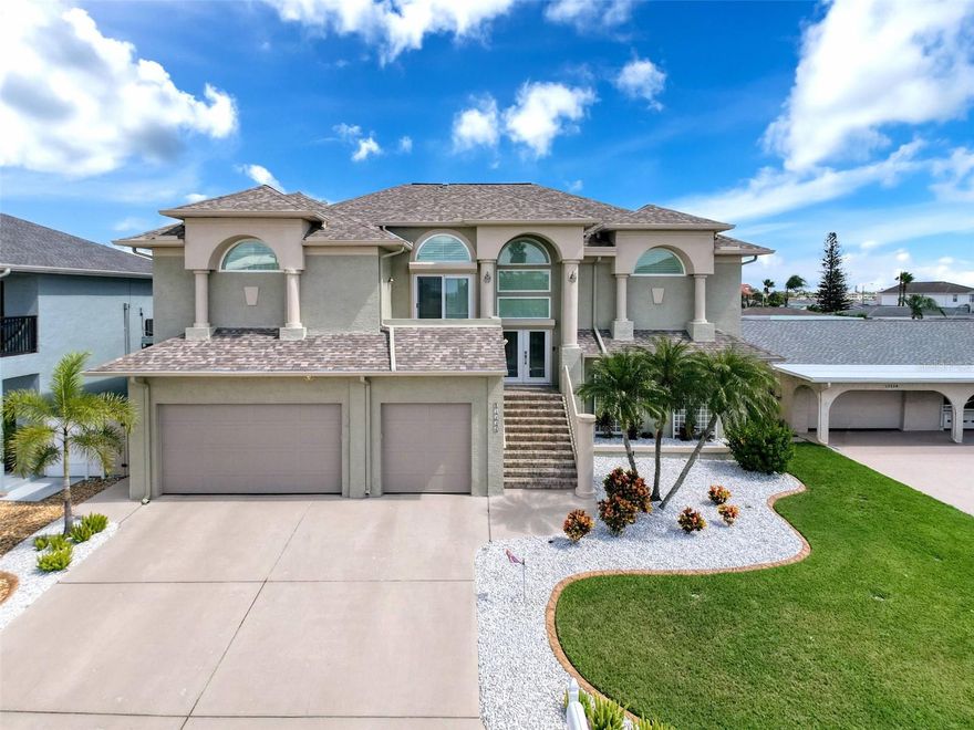 This amazing waterfront home is captivating from the moment you pull into the driveway. The beautiful architecture compels you to go inside. Once you pass through the new hurricane front doors and step up the amazing grand staircase you will encounter 2,527sqft of luxurious Florida living. All rooms have 12ft ceilings and beautiful ceramic tile flooring! Open concept living starts with the natural light shining through every window and door in this amazing home starting in the living room welcoming you at the top of the stairs. Featuring sliding doors to the screened-in porch where you can enjoy the sunrise while sipping your morning coffee and taking in the awesome views of the waterfront in your own backyard. There are 2 archways to enter the eat-in-kitchen that features stainless steel appliances, quartz countertops, soft close drawers, dual sinks, new plumbing and garbage disposal, crown molding, breakfast nook for 4, space for a table of 6 and a sliding door to the screened-in porch. The huge family room features a comforting wood burning fireplace, perimeter shelving and 4 large windows with views of the deep-water canal. The formal dining room boasts crown molding, a beautiful halfmoon window that sits over a sliding door with a hurricane awning that leads out to the balcony for your private viewing of the sunset over the GULF OF AMERICA each and every evening. There are 3 bedrooms (split plan). The large primary bedroom features a huge walk-in closet, perimeter shelving, many windows and a sliding door to the screened-in porch overlooking the water. The primary bath features a walk-in shower, dual sinks, a separate make-up vanity with an abundance of natural light. There are 2 good sized bedrooms on the other side of the home that share a second full bath with a walk-in shower. Take your well-maintained with battery backup hydraulic elevator down to the 1st floor where you will find an oversized garage with brand new hurricane garage doors that can accommodate 6 vehicles or more allowing plenty of room for all of your toys. There is room for storage and a workbench as well. Also, on the 1st level you will find a large bonus living space with a large bedroom, full bath, sitting area with hurricane slider/awning to the paved backyard patio and firepit with views of the deep-water canal. This is a great space for guests, a home office or an in-law suite. On the bulkhead is a boater’s paradise with a huge stationary dock, a 10,000-pound boat lift, a floating dock, a jet ski dock and at night there is underwater lighting to view the sea life up close. Too any updates! (listed in separate attachment). The only way to truly view all that this beautiful home has to offer is in person. Call for your private showing! All your local restaurants like Inn on the Gulf, Sam's Beach Bar, Ollie’s on the Beach and Get Hooked are a 5-minute drive. Sunwest Park is a local waterfront attraction that is nearby as well. The Bayonet Point Hospital, many local supermarkets and the Port Hudson Marina are all located right here in Hudson, Florida. The Tampa Bay Airport, Tampa Bay, Clearwater Beach, Homosassa Springs, Tarpon Springs, Pine Island, Honeymoon Island and Weeki Wachee are all under an hour away. Fish & crab off your own lighted dock or take a kayak, jet ski or boat ride to the open Gulf where the fish are plentiful, the fun is never ending and the sunsets are always awesome! COMES COMPLETLY FURNISHED (minus personal items) for the right offer!