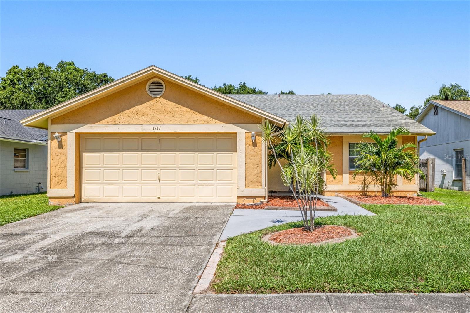 One or more photo(s) has been virtually staged. Welcome to this surprisingly spacious 3-bedroom, 2-bathroom, 2-car garage single family home in a prime location with low HOA fees, no CDD and no rear neighbors. This move-in ready home features an open floorplan with vaulted ceilings, creating a spacious and airy feel in the large main living area. There is no carpet in the home only tile in the main living areas. All 3-bedrooms have laminate flooring, ceiling fans and walk-in closets. Bathroom-2 is strategically located for guests and residents and contains extra cabinets for additional storage. There is also a large storage closet in the living quarters hallway. The spacious kitchen features a breakfast bar, granite countertops, all appliances and room for a breakfast table perfect for everyday cooking and entertaining. The roomy primary bedroom has a large walk-in closet and the updated master bath features a large vanity for extra storage and a custom stone step-in shower. Home also features a large 26x18 screened lanai for bug-free outdoor enjoyment, a partially fenced backyard and a charming front porch. Some of the homes other features include; private mailbox, rain gutters, oversized 2+ car garage w/opener, window treatments, ceiling fans and French doors. Meadowbrooke at Summerfield is a well-established community in a fantastic location close to schools, shops, restaurants and I-75. Summerfield residents enjoy many amenities. The nearby Community Center is equipped with two pools, an indoor basketball gym, fitness rooms with weights, elliptical machines, stationary bikes, treadmills, tennis courts, a volleyball court, dog park, playground, pavilion and a new rental hall that can be rented out for special events.